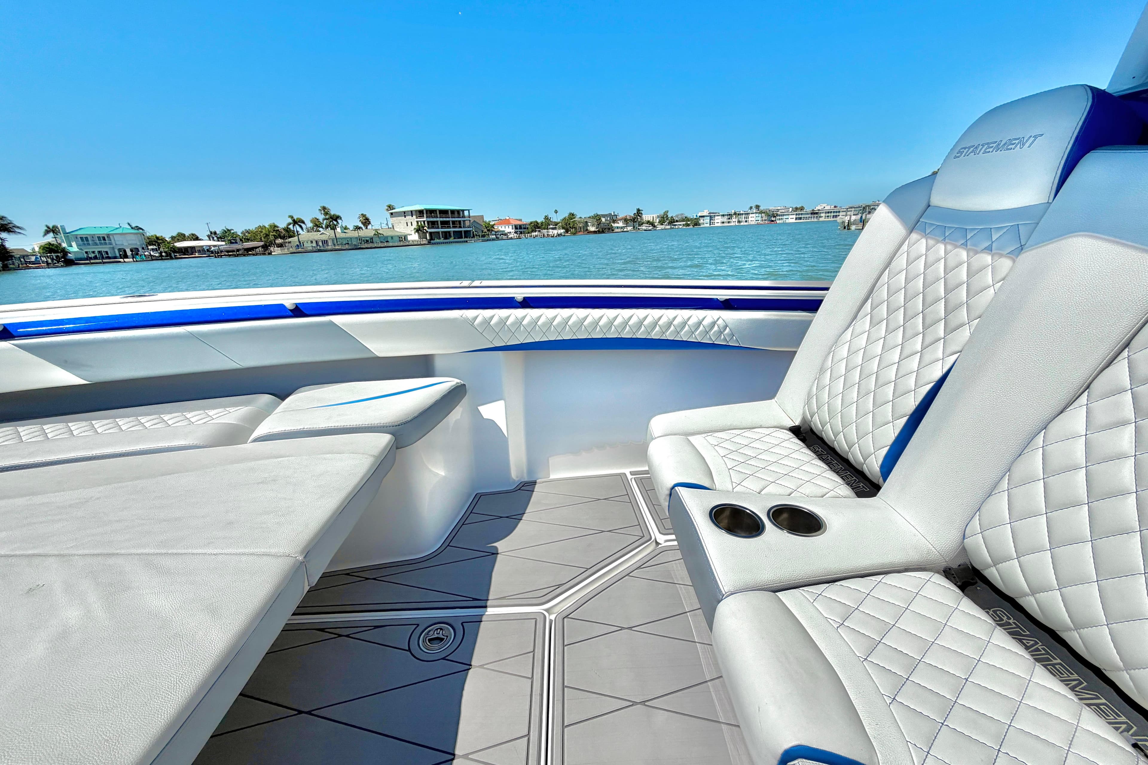 Luxurious interior of 2022 Statement 350 Open boat with quilted seating and ocean view.