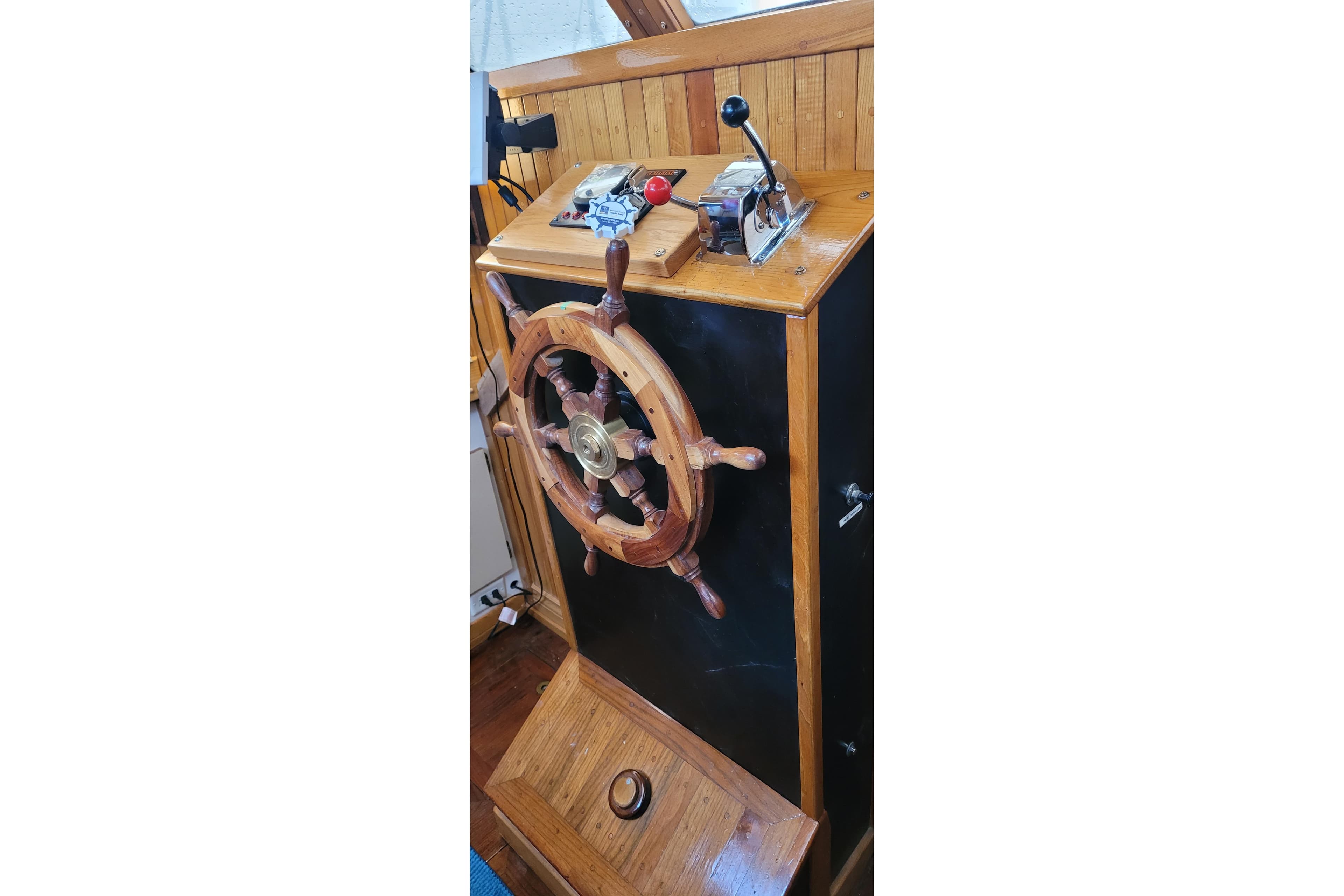 Wooden helm and controls of a 1983 Corbin 39 sailboat.