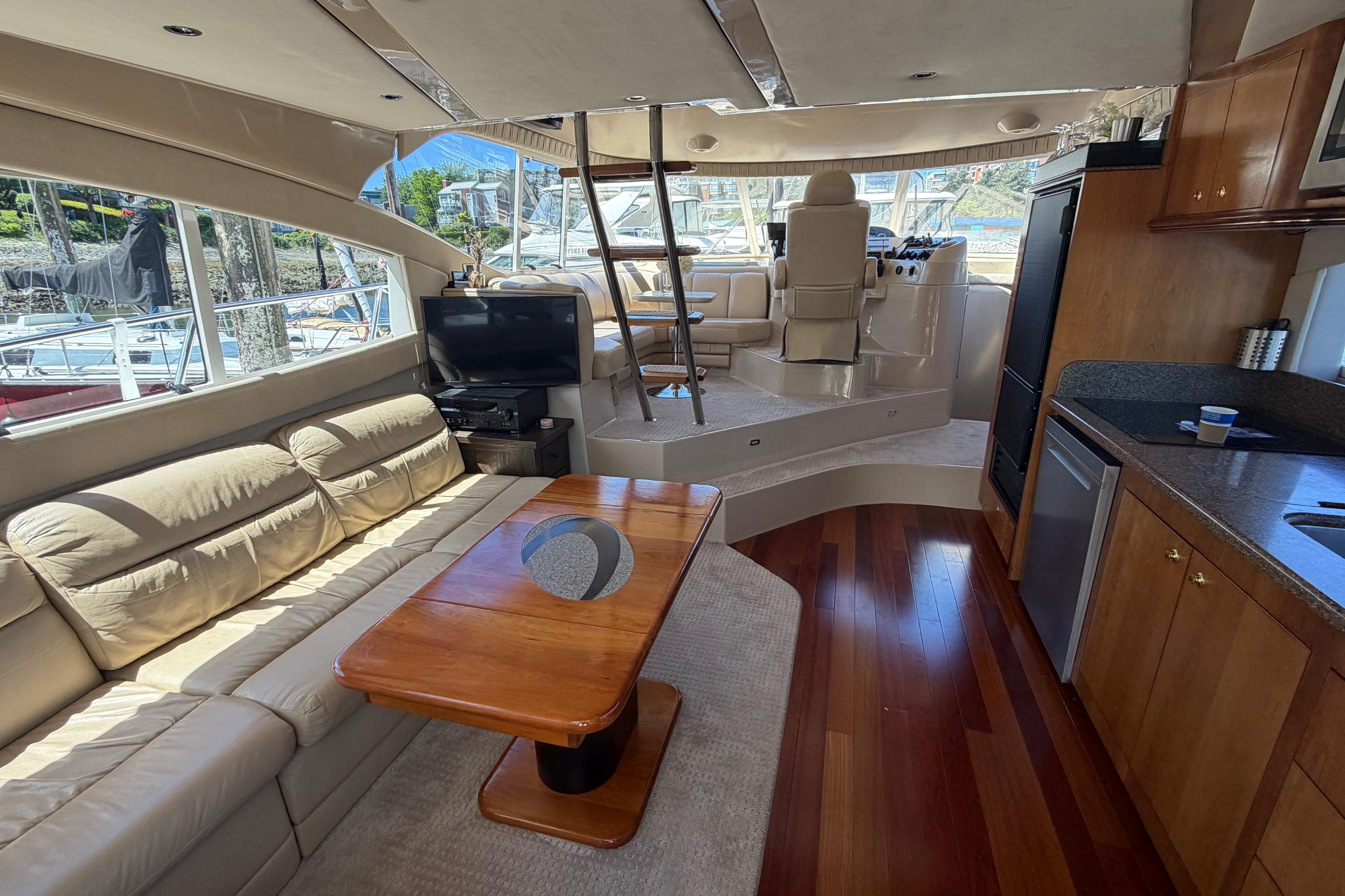 Luxurious interior of 2001 Cruisers Yachts 5000 Sedan Sport with leather seating and wood finishes.