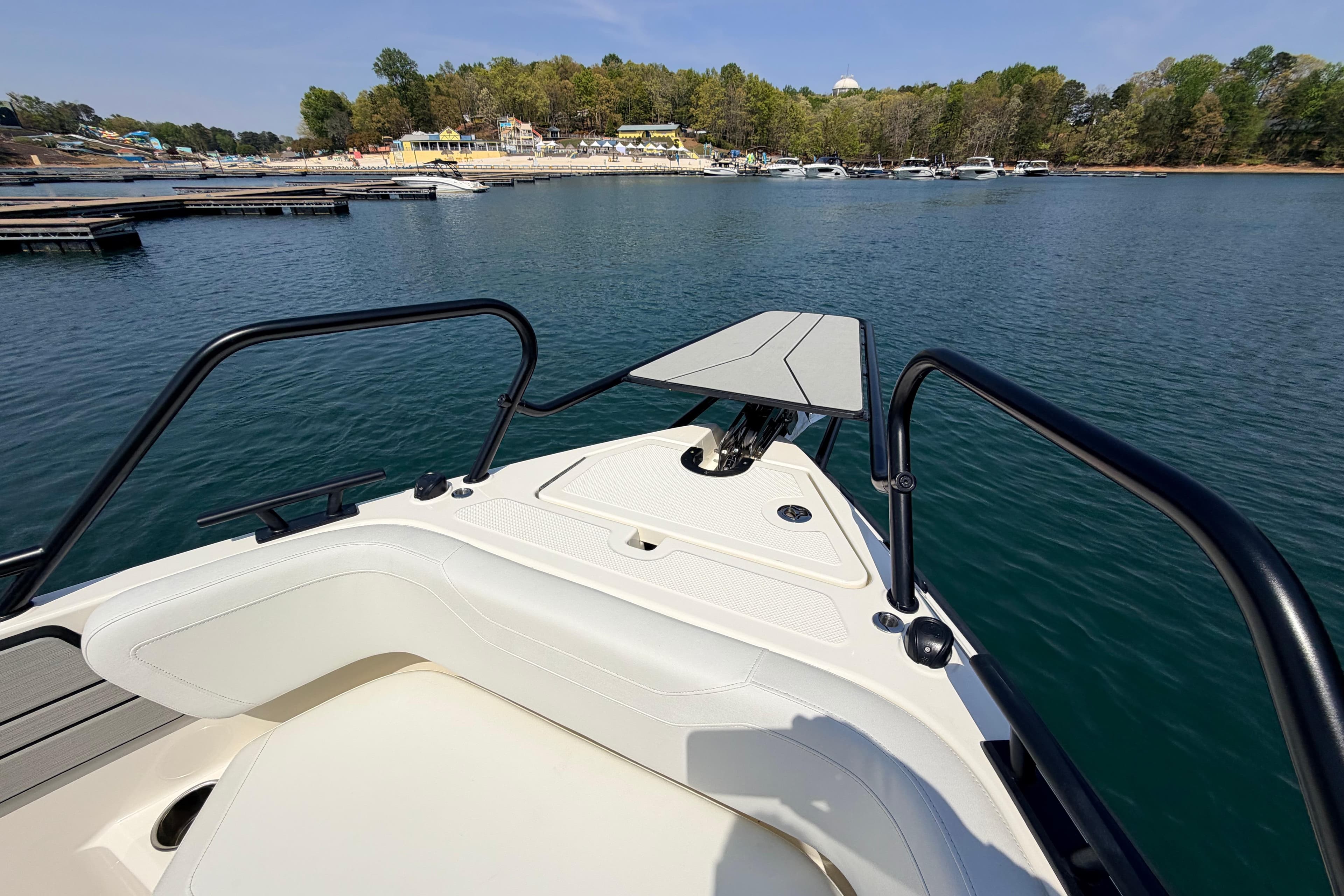 Bow view of 2027 Navan T30 boat docked on a serene lake.