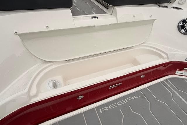 2021 Regal 2800 Bowrider boat interior with storage compartment and branded flooring.