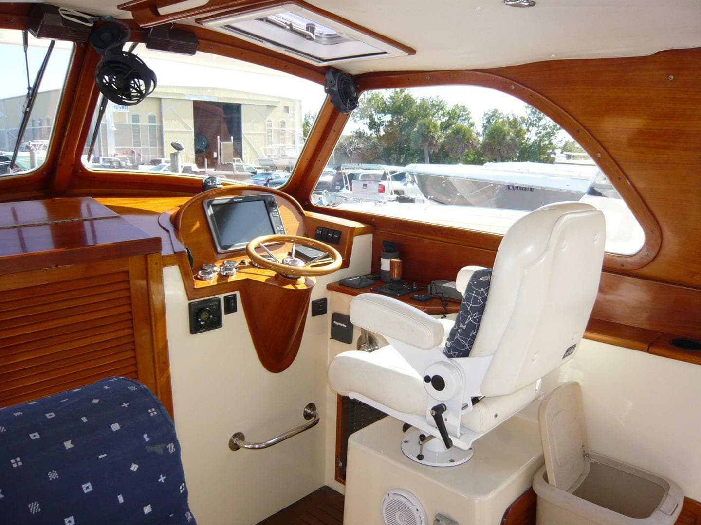 Interior of 1998 Hinckley 36 Classic boat with wooden dashboard and captain's chair.