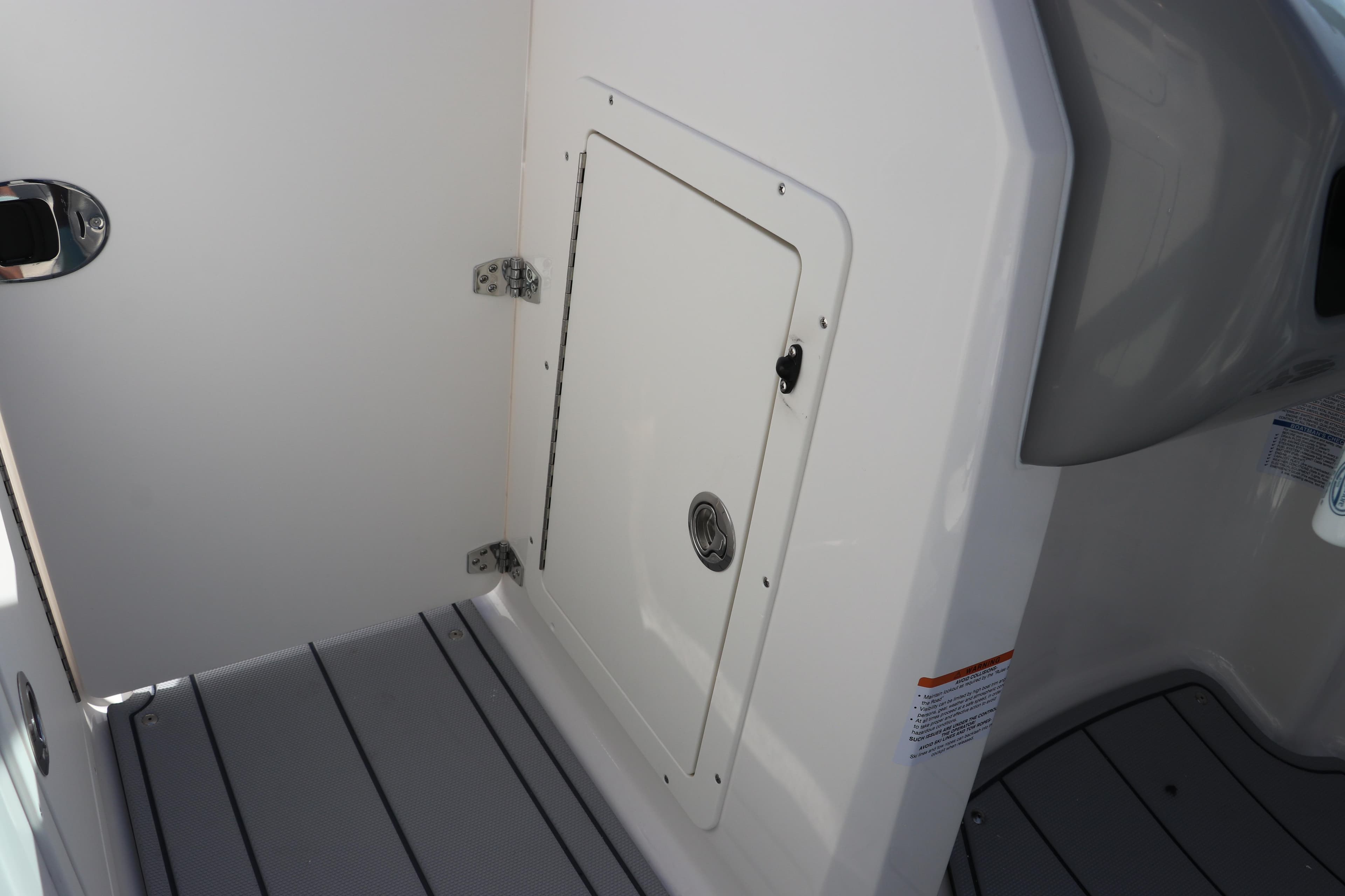 Interior view of 2026 Chaparral 21 SSi OB boat, featuring a storage compartment.