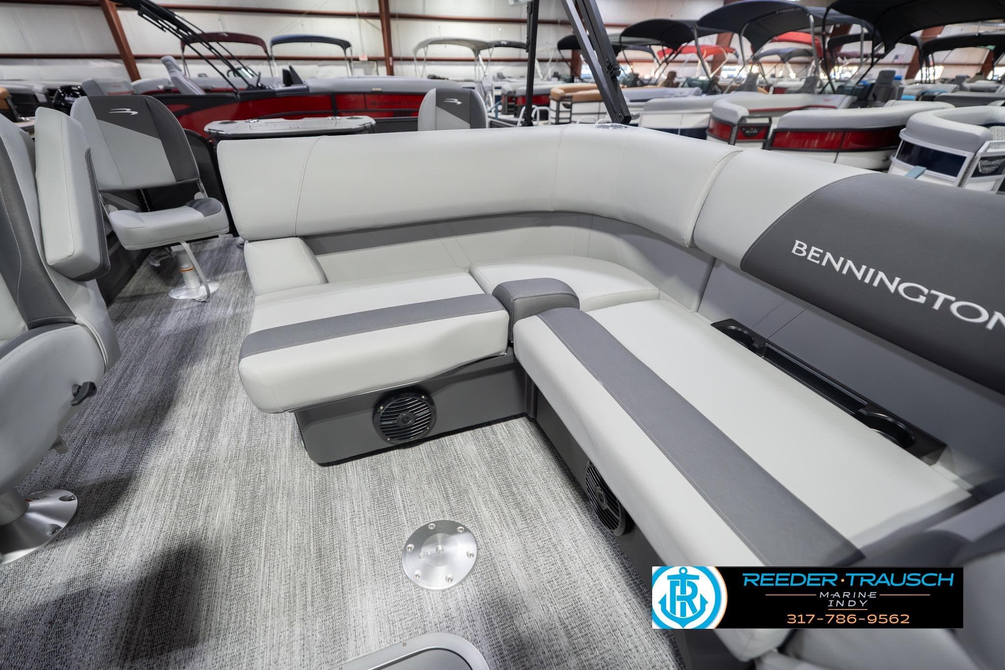 2026 Bennington 22 SF boat interior with gray seating and carpeted flooring.