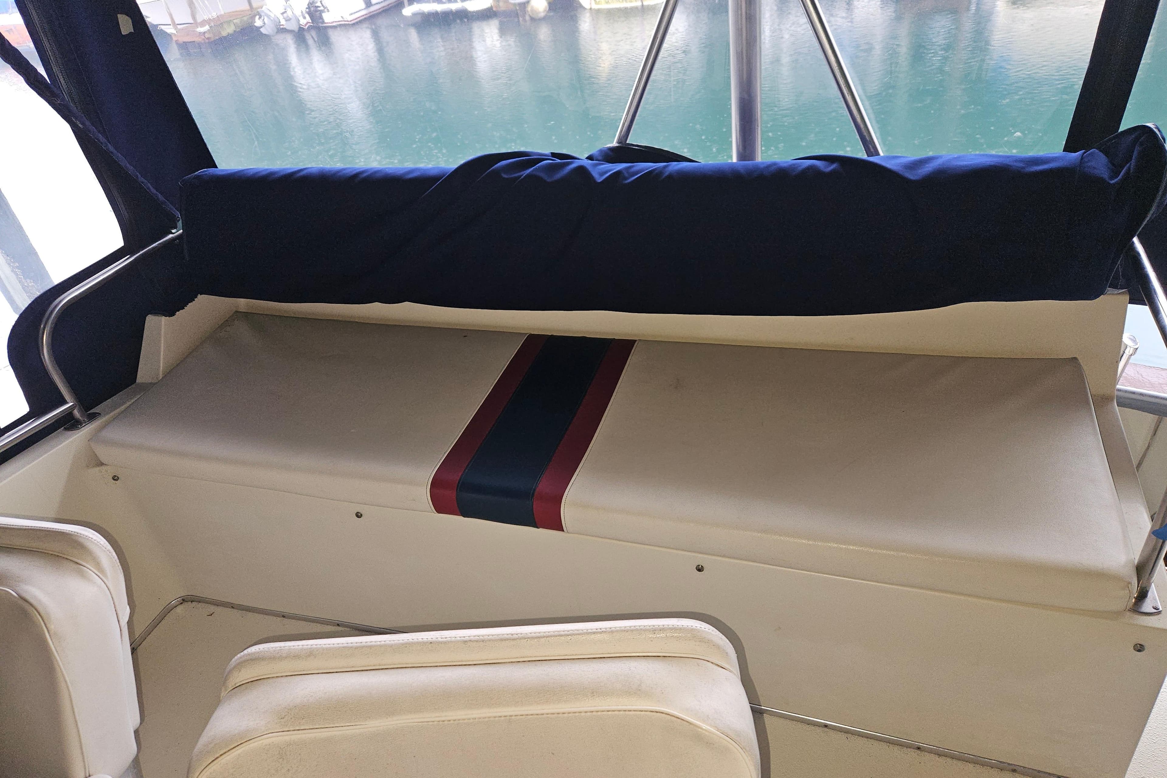 1989 Tollycraft Sport Sedan interior seating with nautical-themed upholstery.