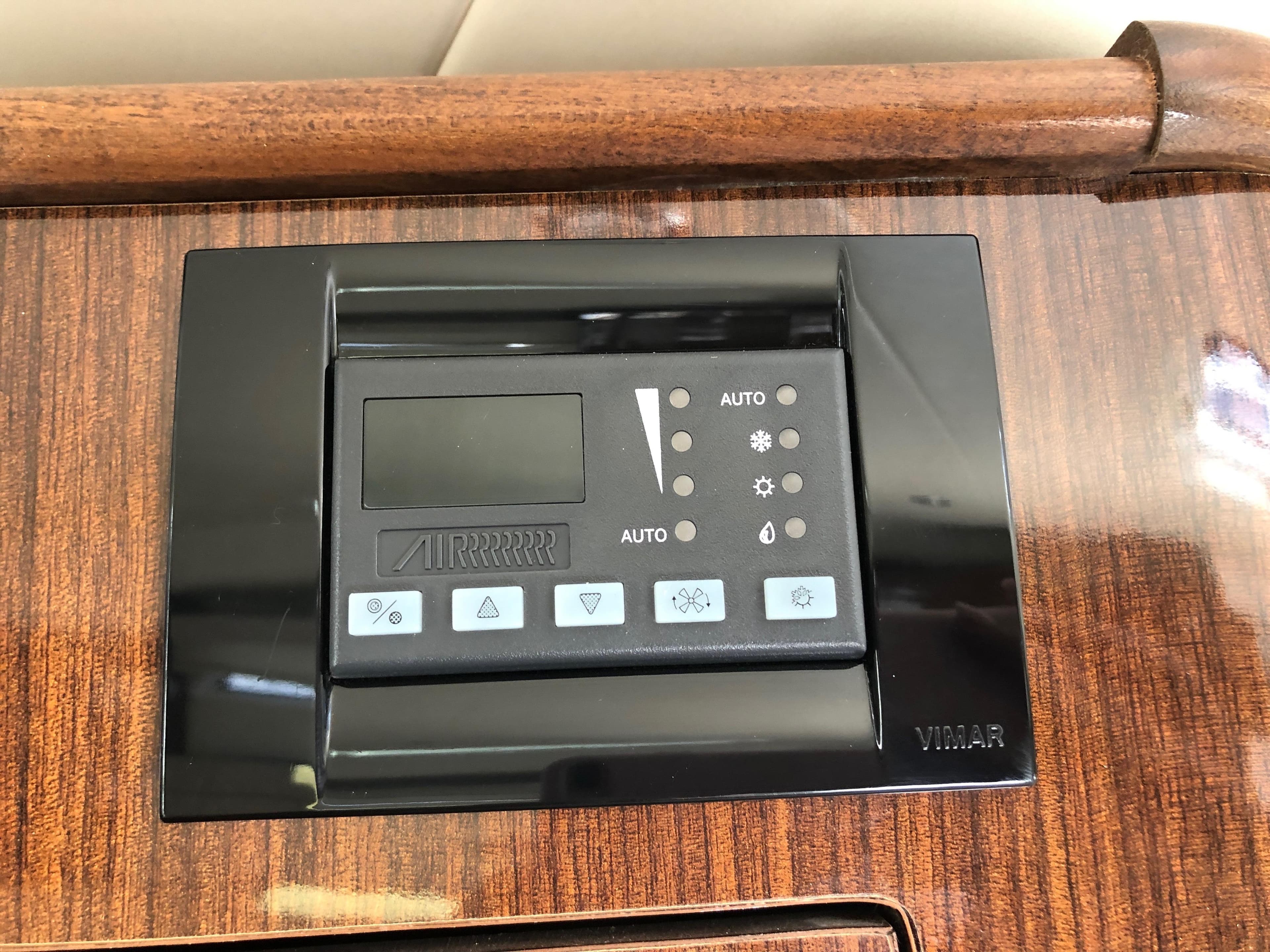 Control panel on 2013 Regal 35 Sport Coupe, featuring wood finish and digital display.