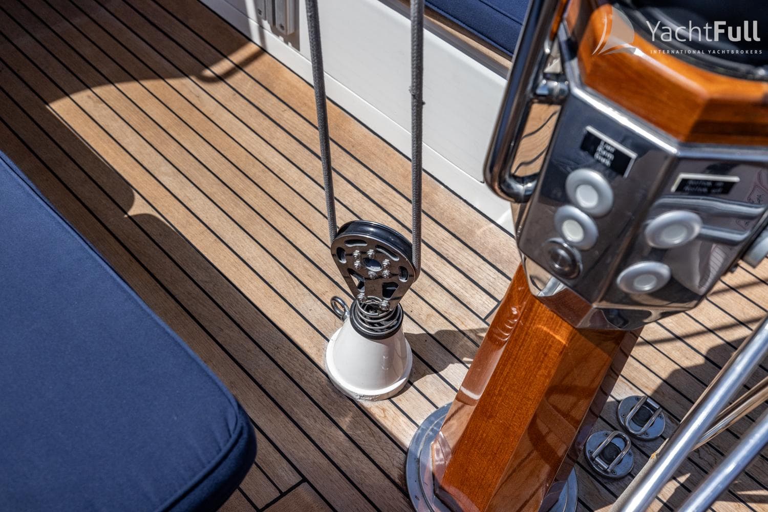Teak deck of a 2000 Bestevaer 50 yacht with winch and steering details.