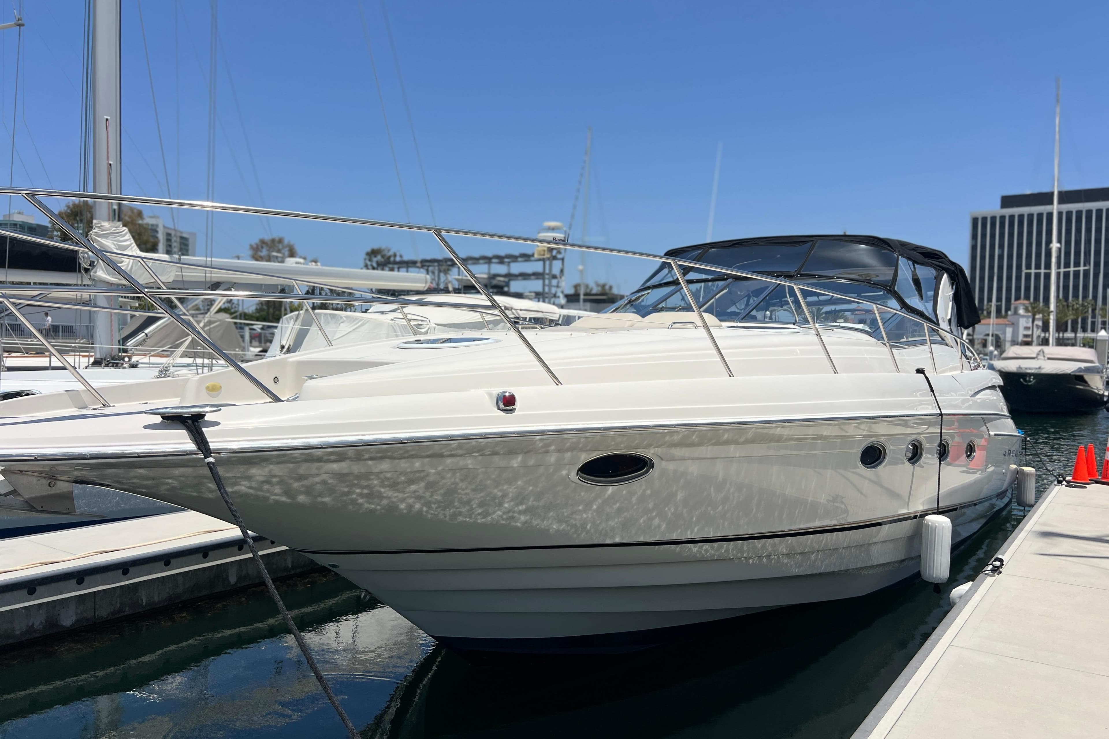 2000 Regal Commodore 4160 yacht docked at marina under clear blue sky.