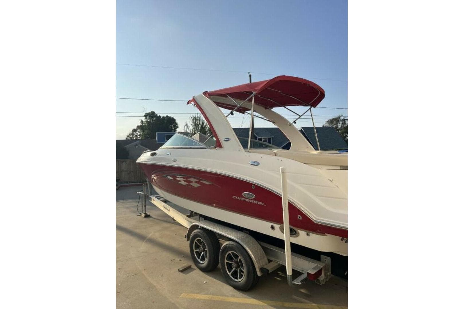 2006 Chaparral 256 SSi boat with red and white design on a trailer.