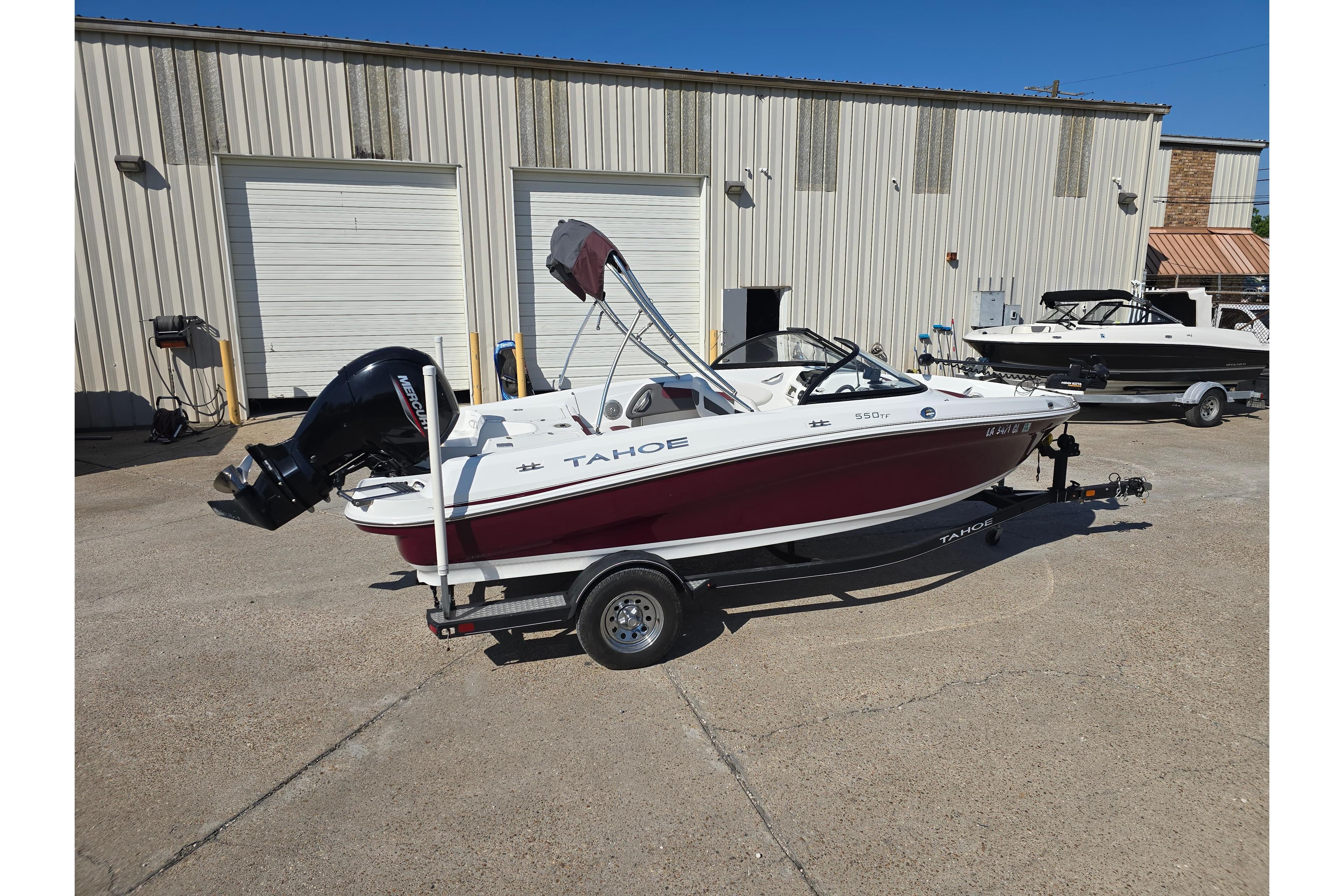 2020 Tahoe 500 TF boat on trailer, parked outside a warehouse.