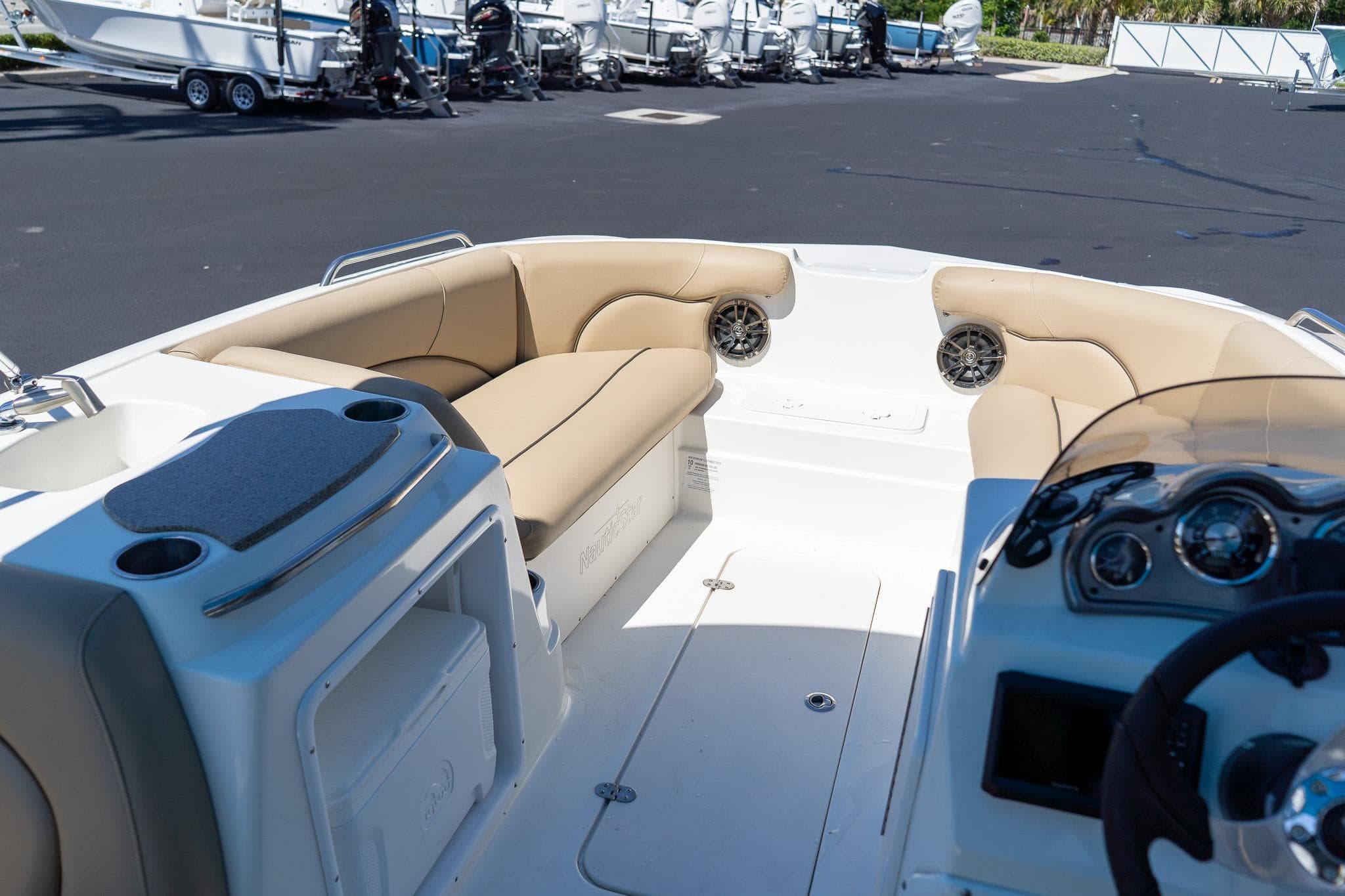 2020 NauticStar 203 SC boat interior with beige seating and dashboard view.