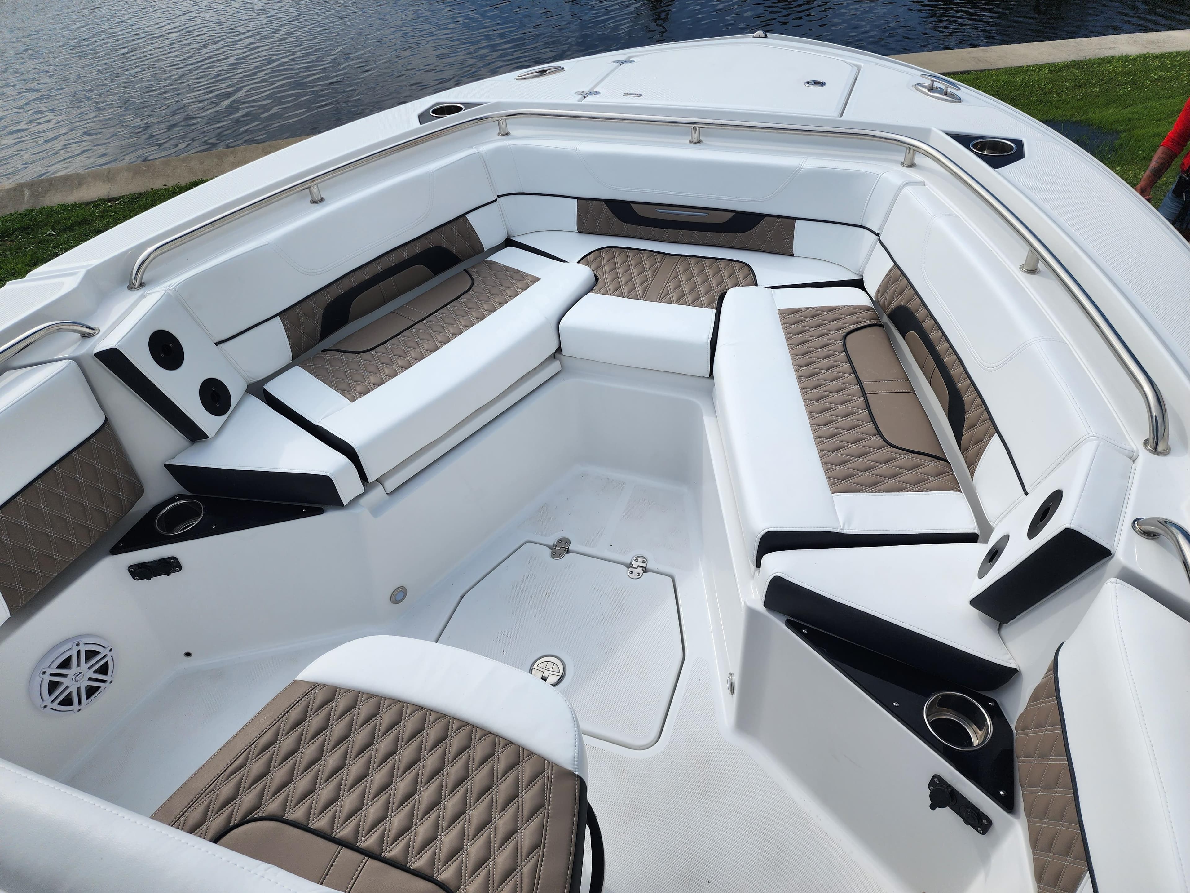 2024 Blackfin 252 CC boat interior with cushioned seating and cup holders.