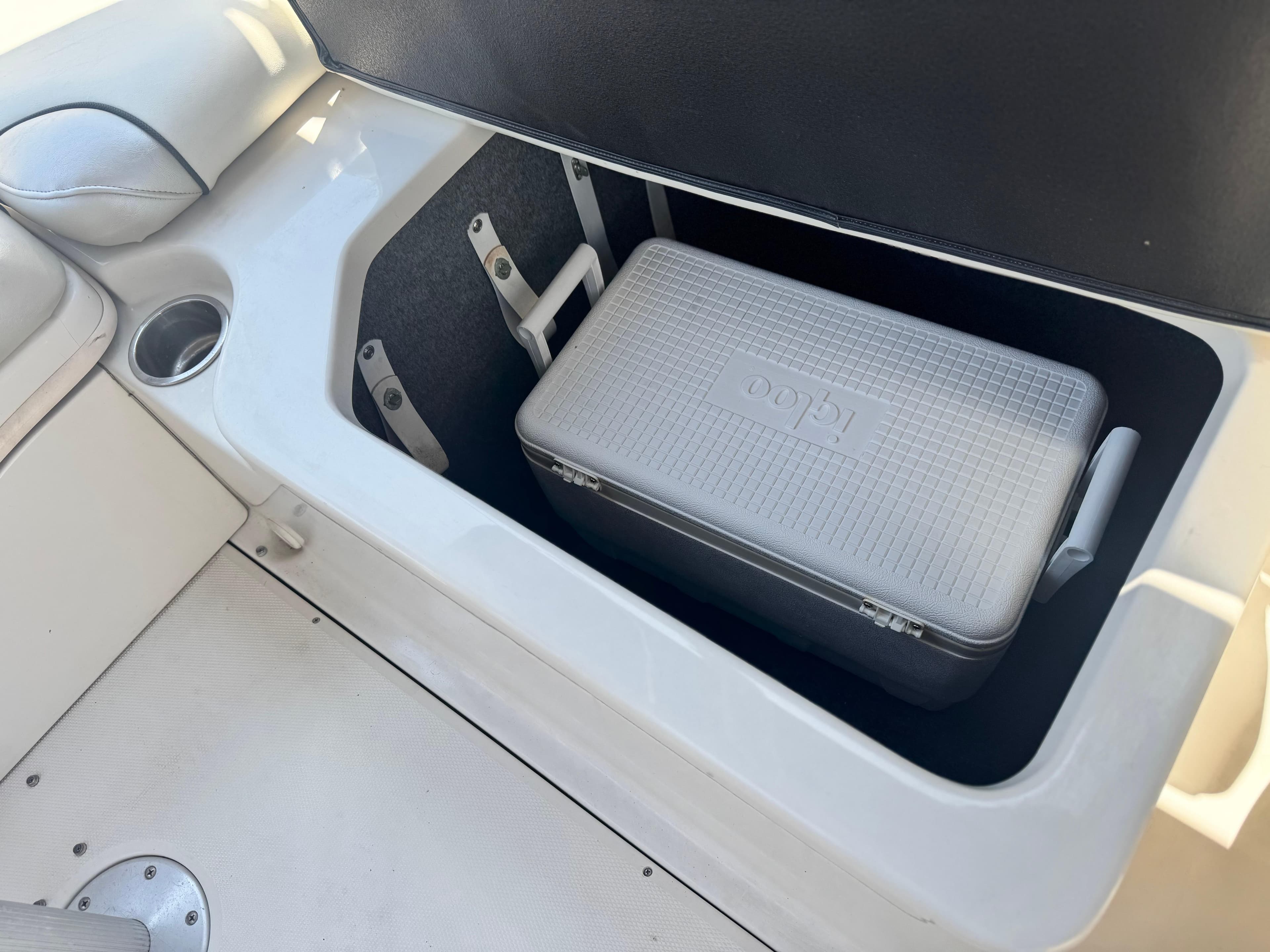 Storage compartment with cooler on a 2005 Sea Ray 240 Sundeck boat.