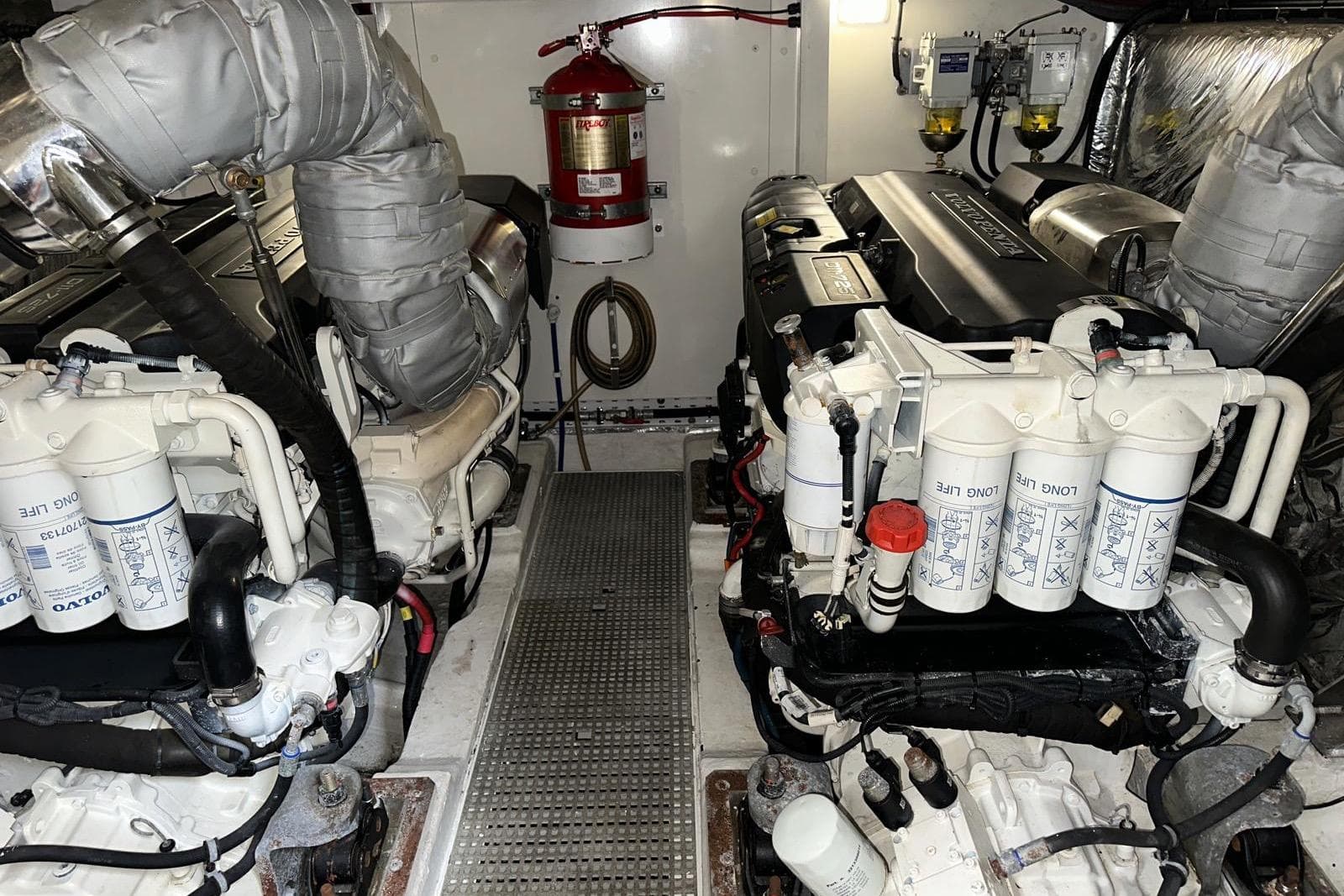Engine room of a 2015 Princess 52 yacht, featuring dual engines and fire safety equipment.