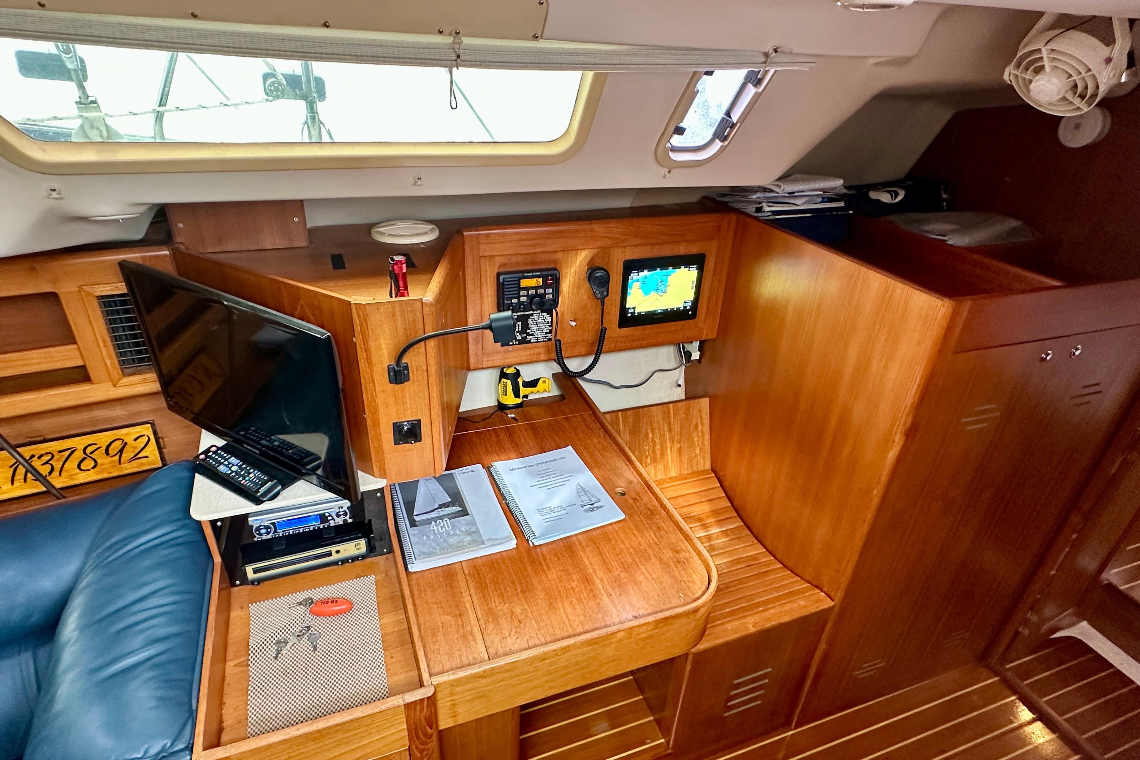 Interior of 2002 Hunter Passage 420 yacht with navigation station and electronics.