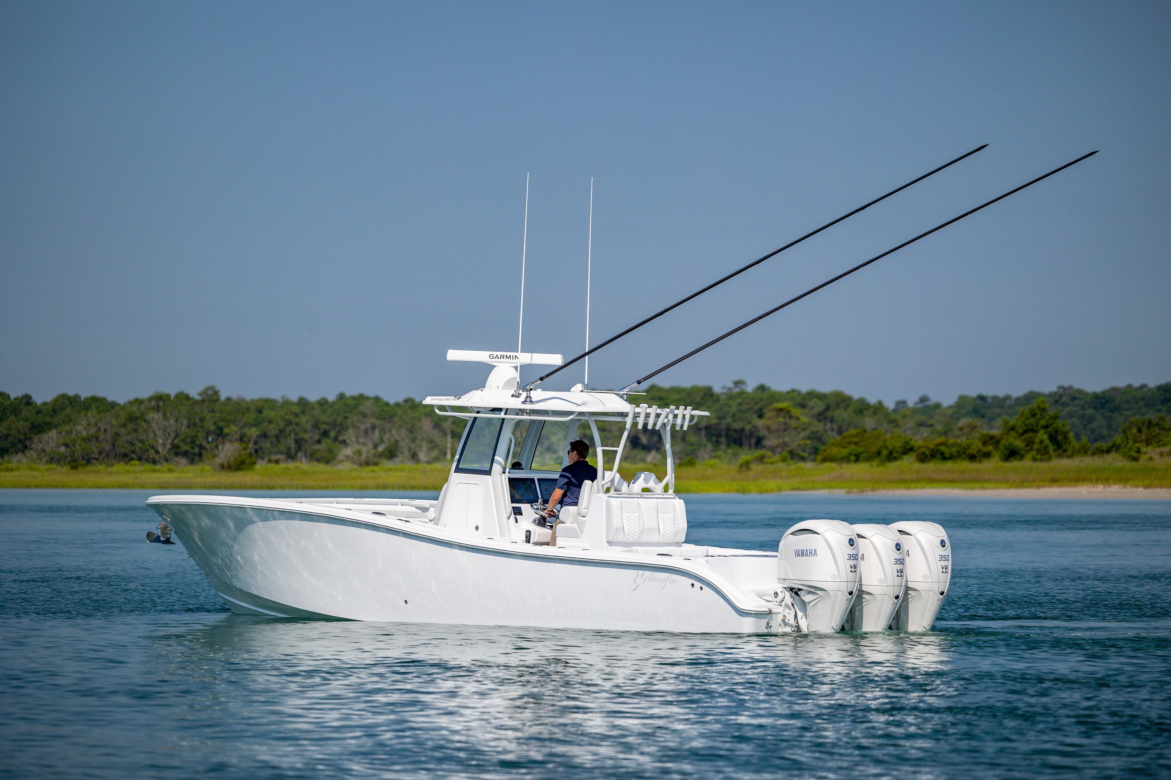2026 Yellowfin 36 Offshore boat with triple Yamaha engines on calm water.
