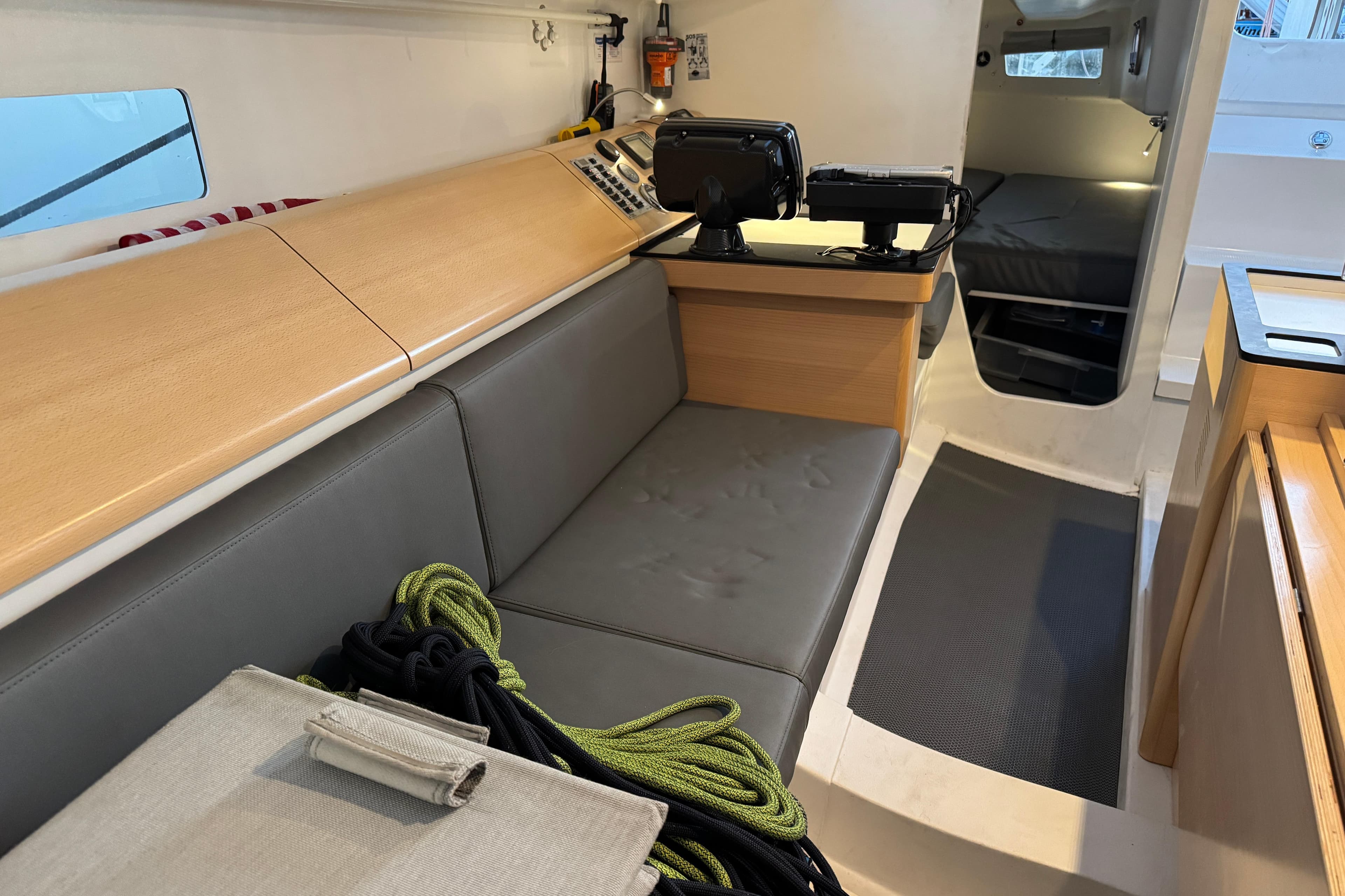 Interior of 2019 Pogo 36 sailboat with seating, navigation equipment, and storage.