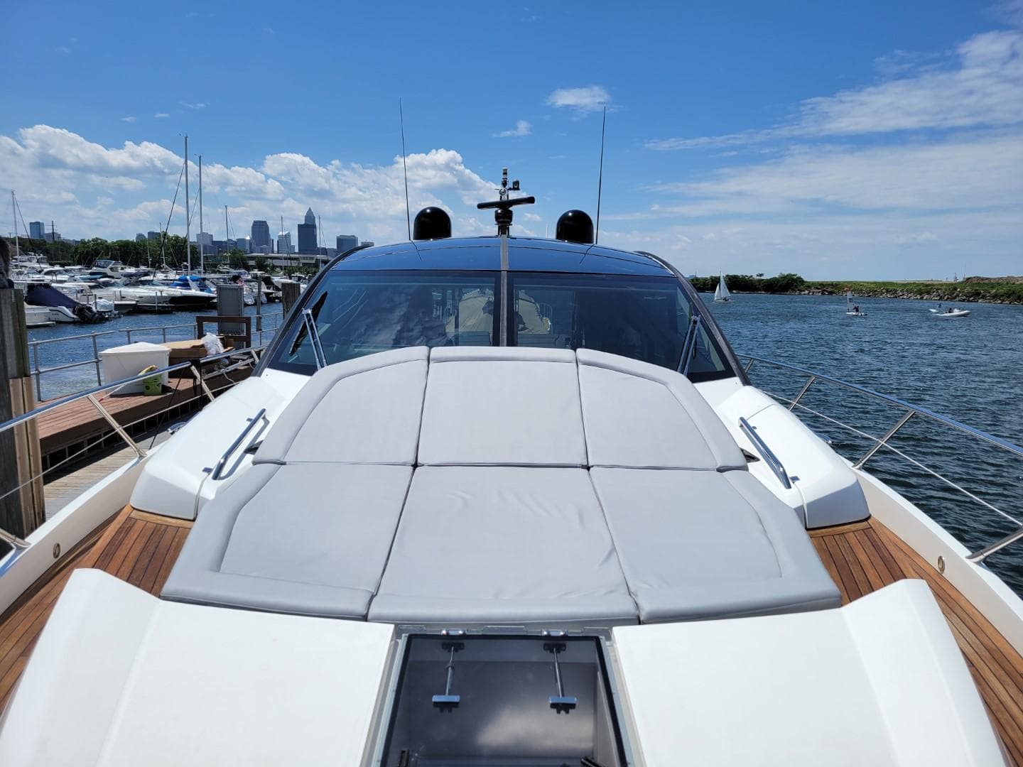 2014 Sunseeker 68 Predator yacht docked at marina with city skyline in background.
