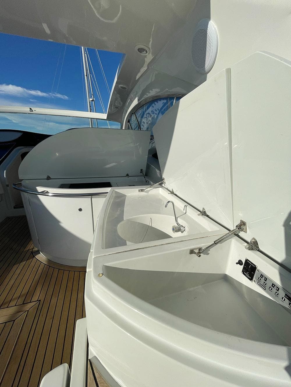2001 Pershing 52 yacht deck with sleek white cabinetry and wooden flooring.