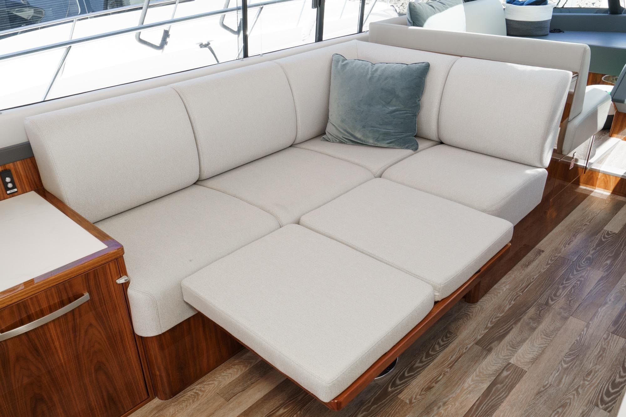 Luxurious interior of 2024 Riviera 5400 Sport Yacht with plush seating and elegant wood finish.