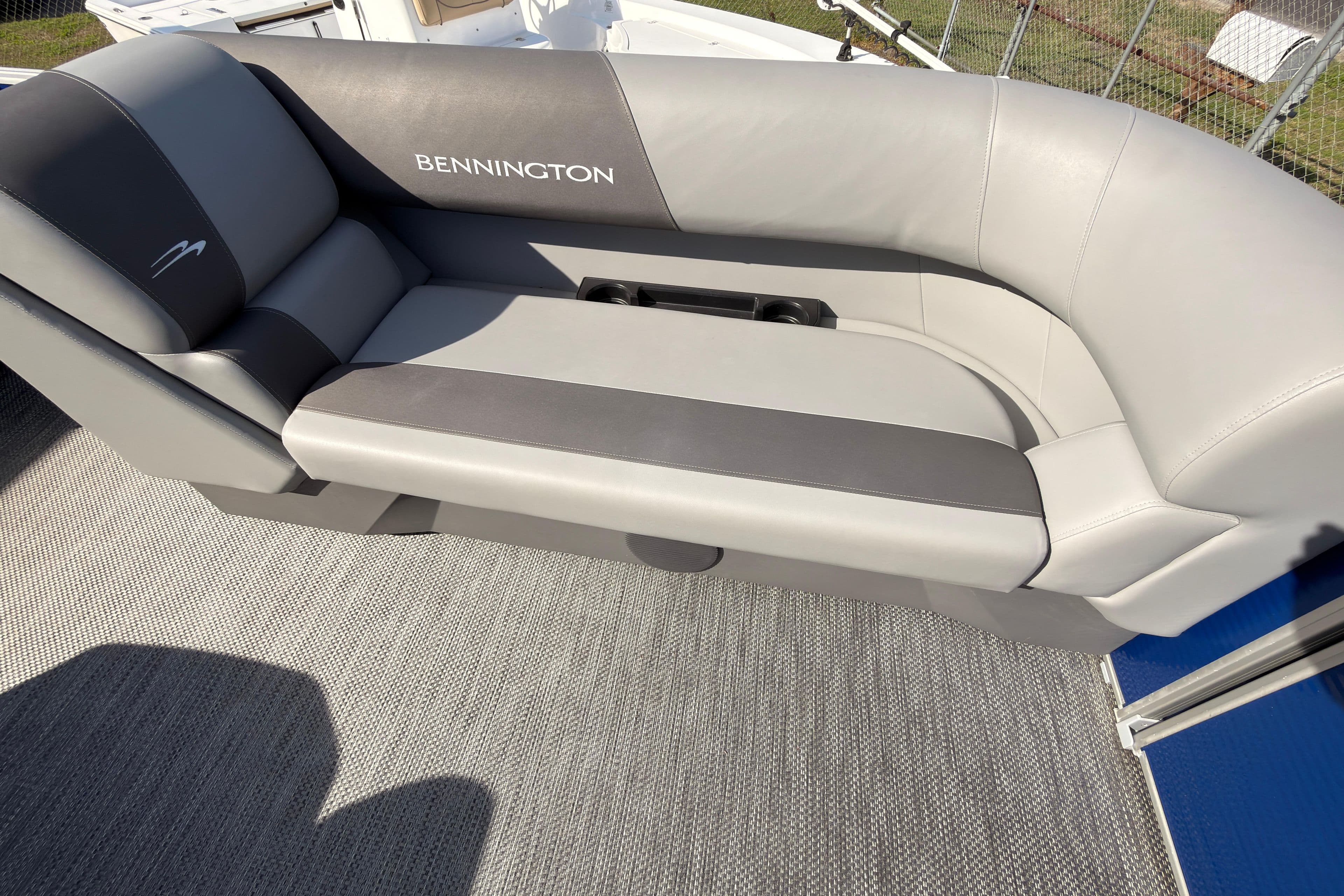 2024 Bennington SVL boat seat with gray upholstery and integrated cup holders.