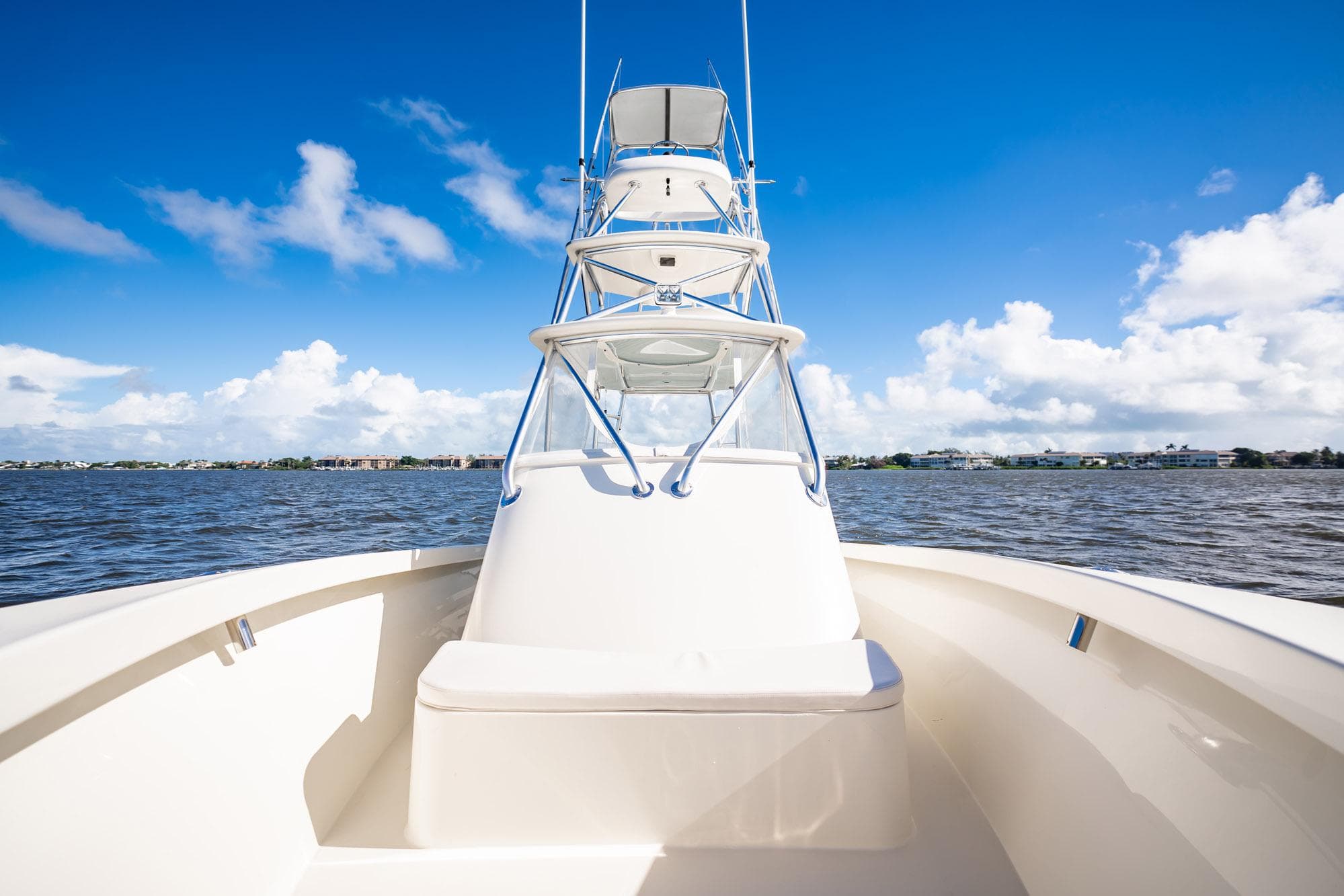 2003 Gamefisherman 34 Express boat on open water under clear blue sky.