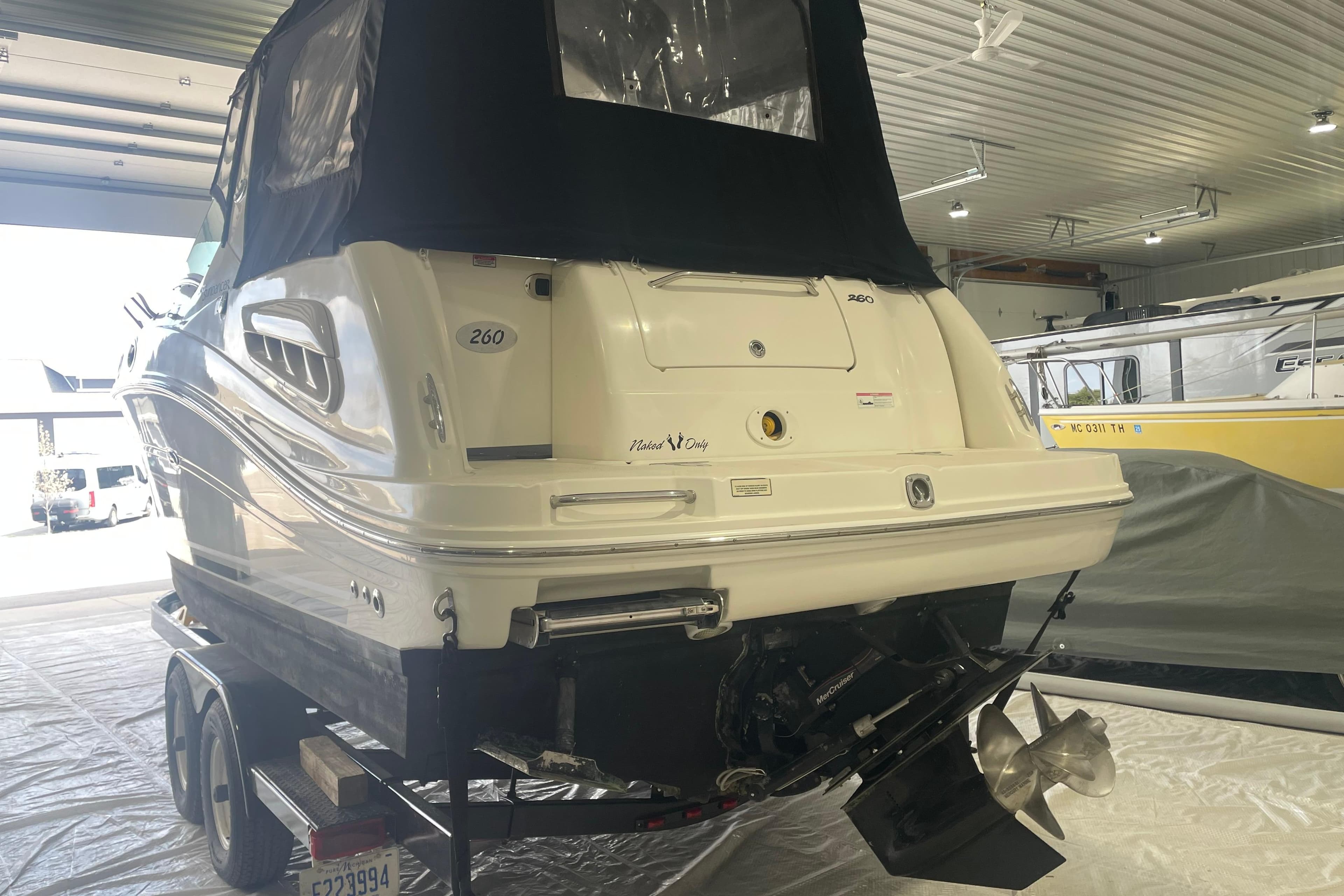 2006 Sea Ray Sundancer 260 boat in indoor storage on a trailer.