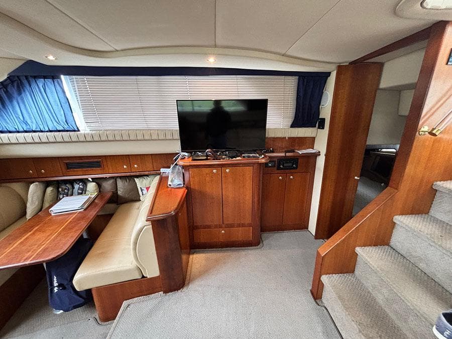 Interior of 2004 Cruisers Yachts 375 Motoryacht with TV, dining area, and stairs.