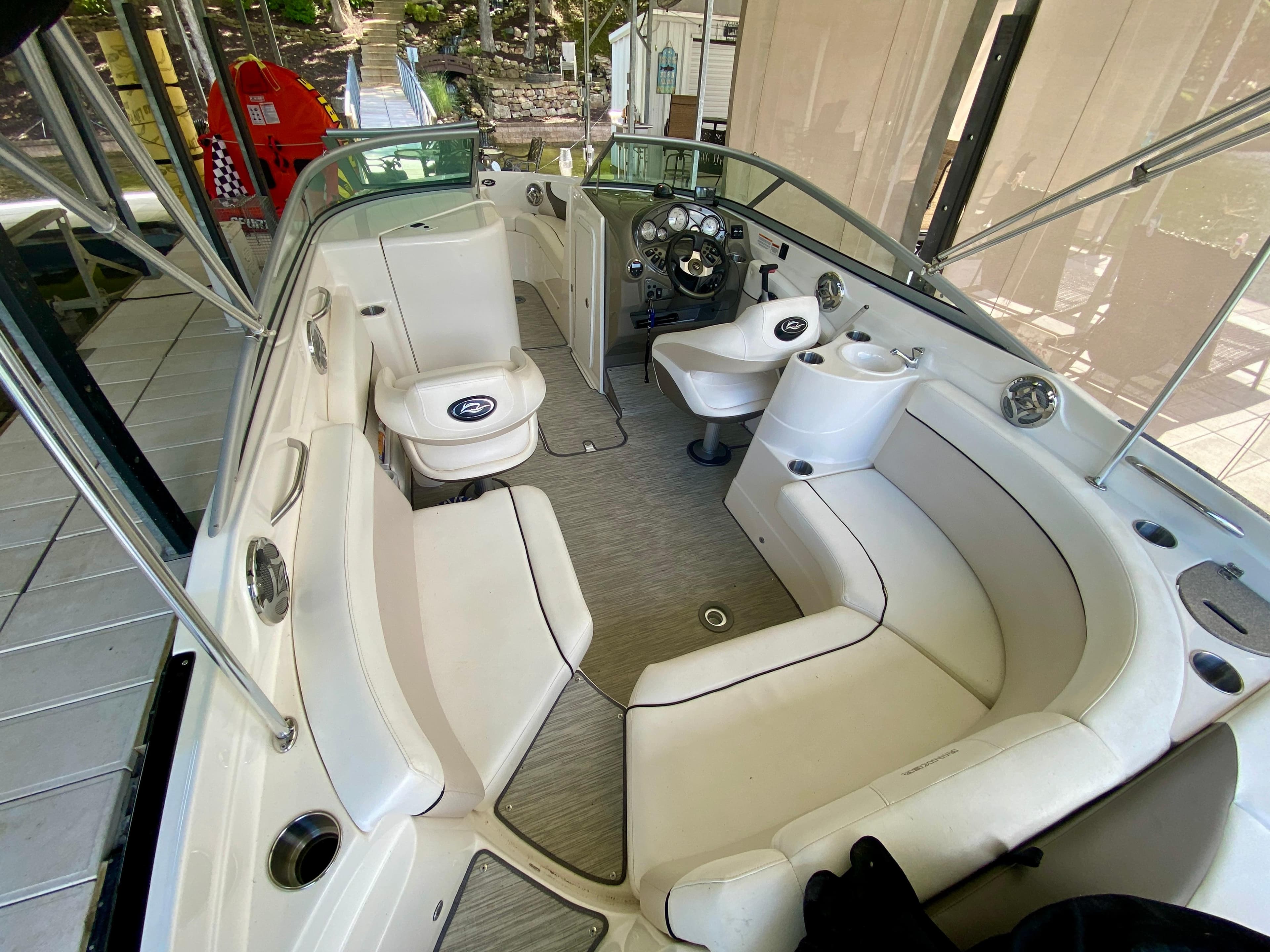 2008 Rinker 246 Captiva Bowrider interior with white seating and steering console.