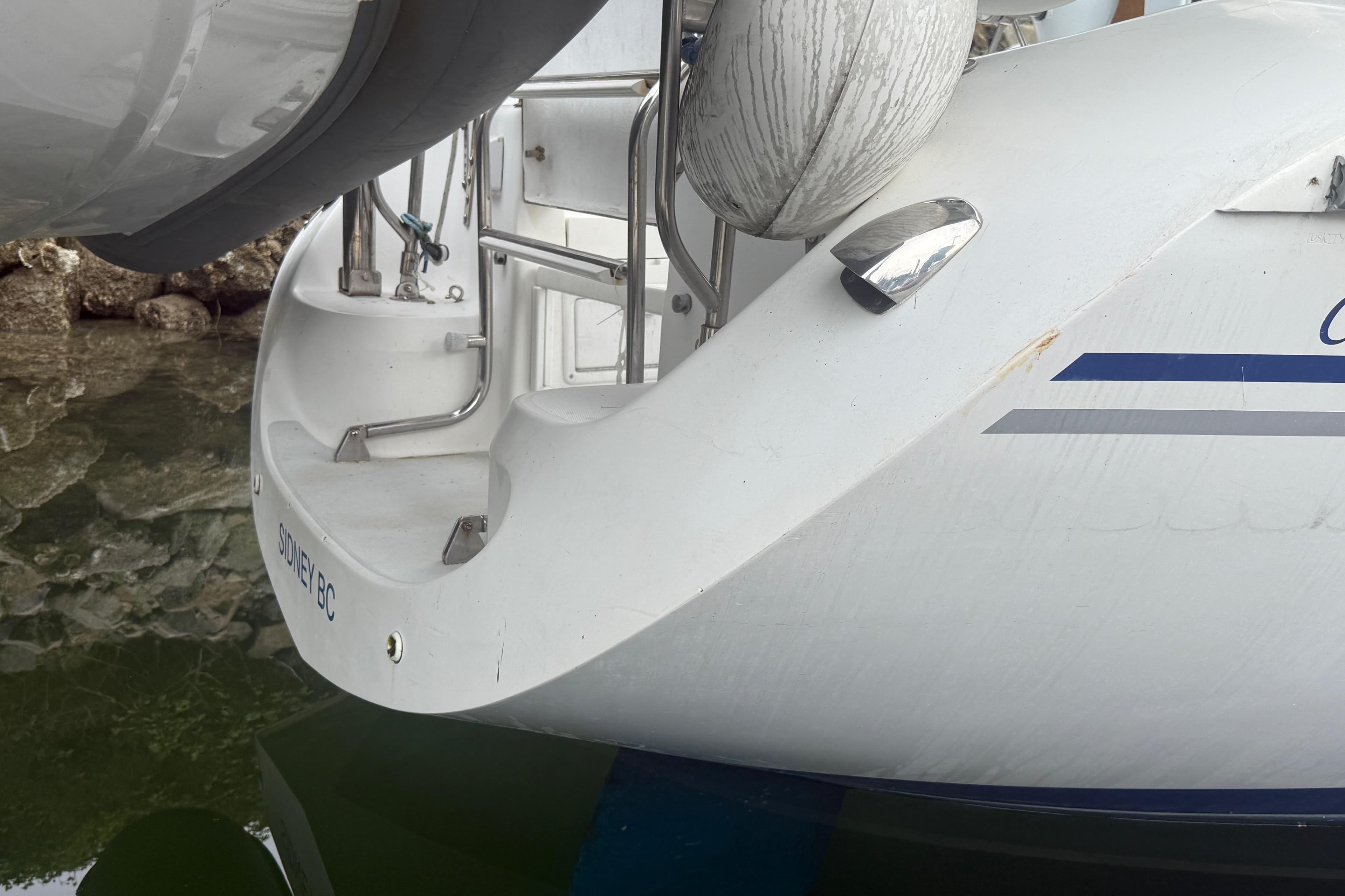2003 Catalina 34 MkII sailboat stern with fender, docked in Sidney, BC.
