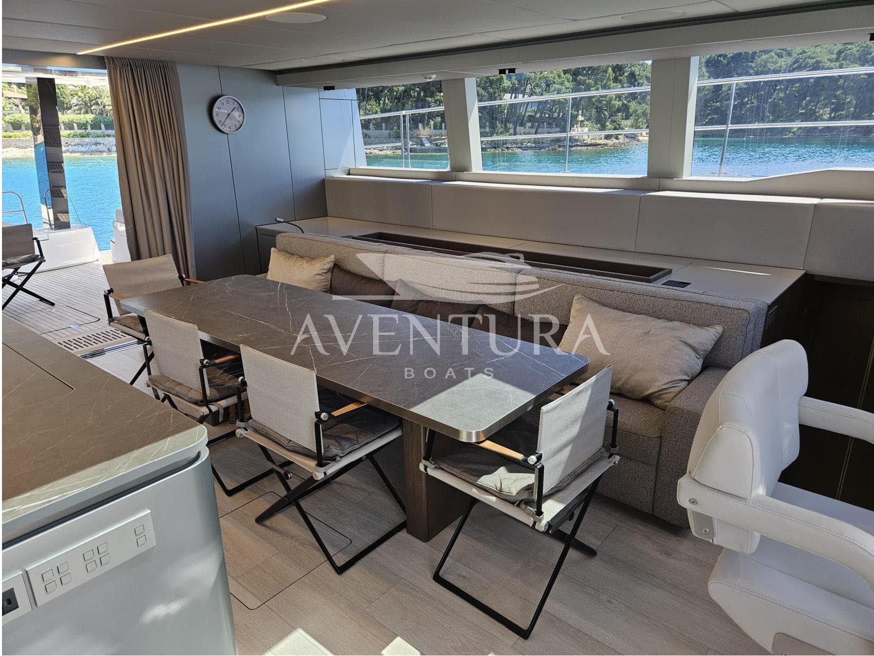 Luxurious interior of 2021 Sunreef 60 Power yacht with elegant dining area and scenic views.