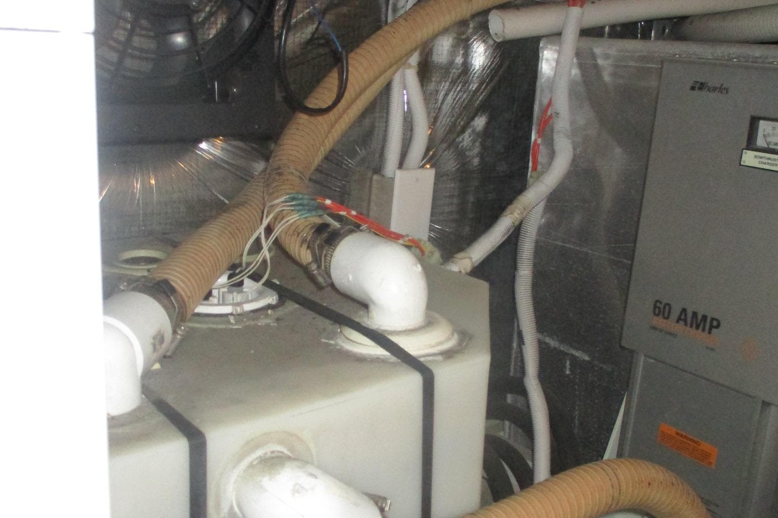 Engine room of 2006 Carver 466 Motor Yacht with wiring and ventilation.