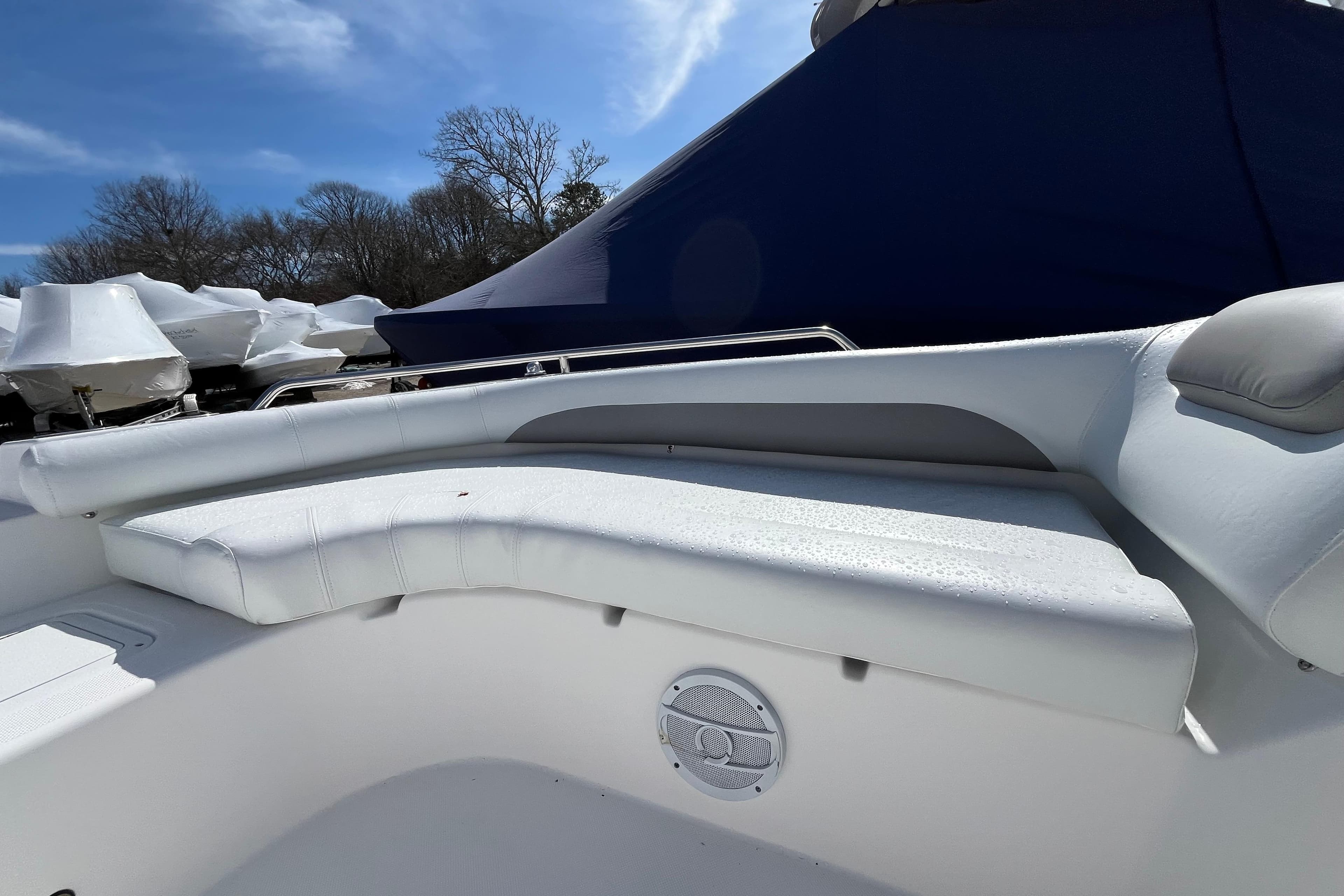 2015 Hurricane SunDeck Sport 201 OB boat interior with white seating and speaker.