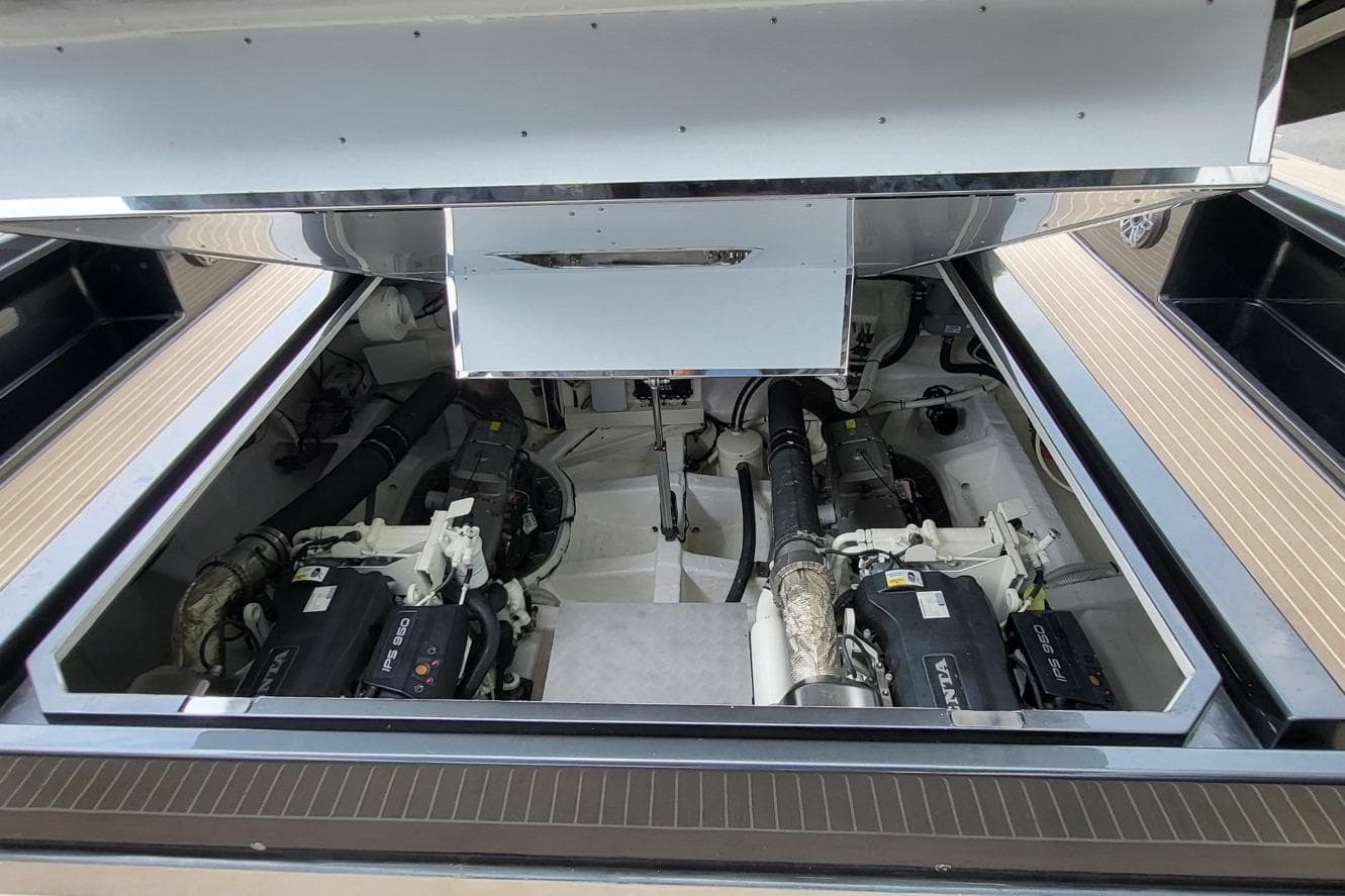Engine compartment of 2023 VanDutch 56 yacht, showcasing dual engines and mechanical components.