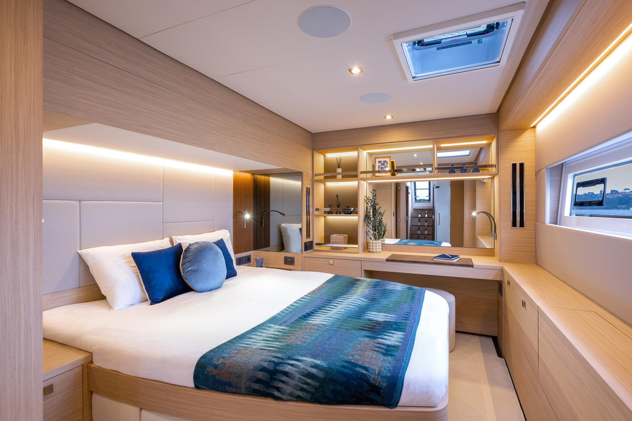 Luxurious interior of 2025 Lagoon 60 yacht with modern bedroom design.