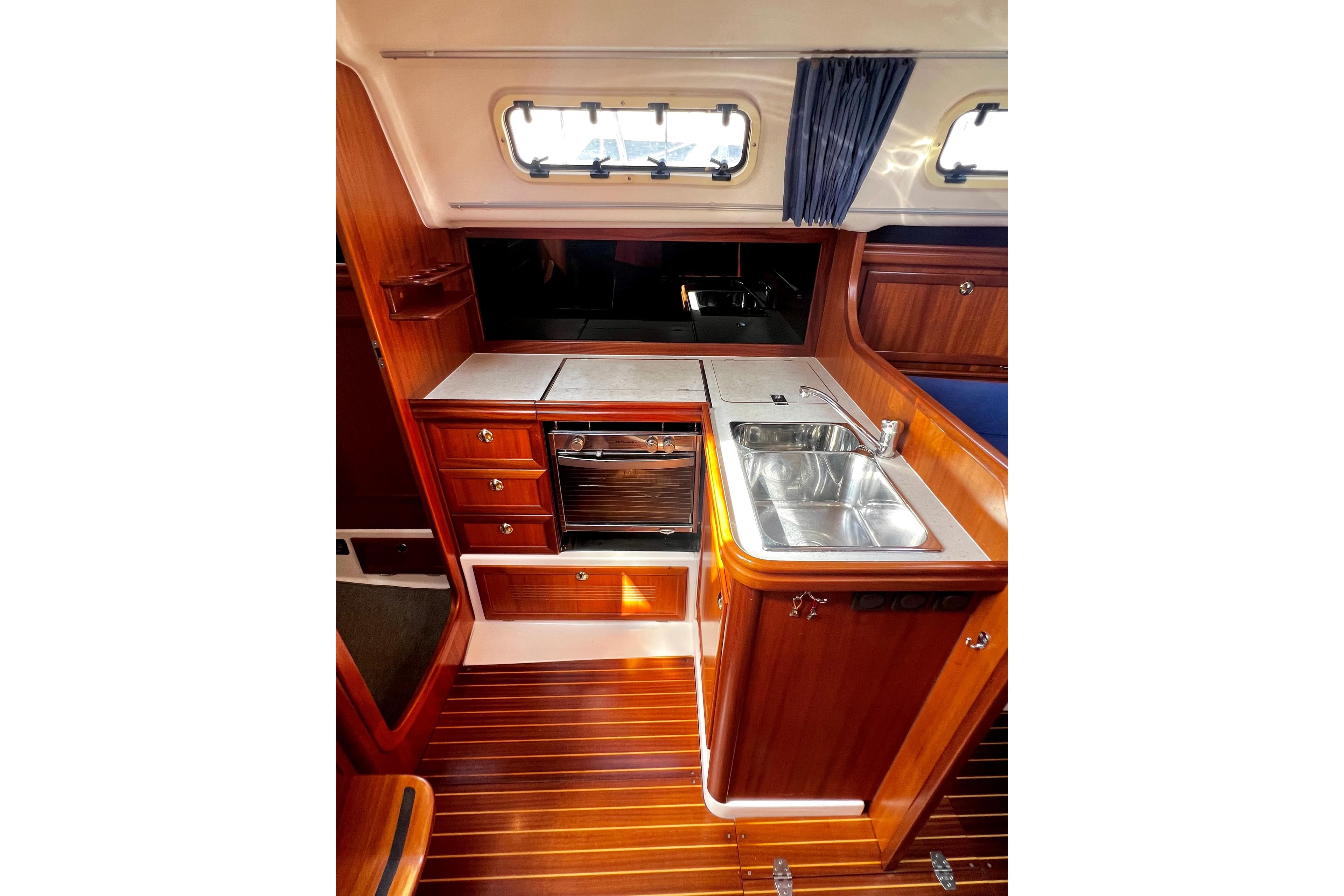 2004 Adria Event 34 yacht interior with wooden cabinetry and compact kitchen area.