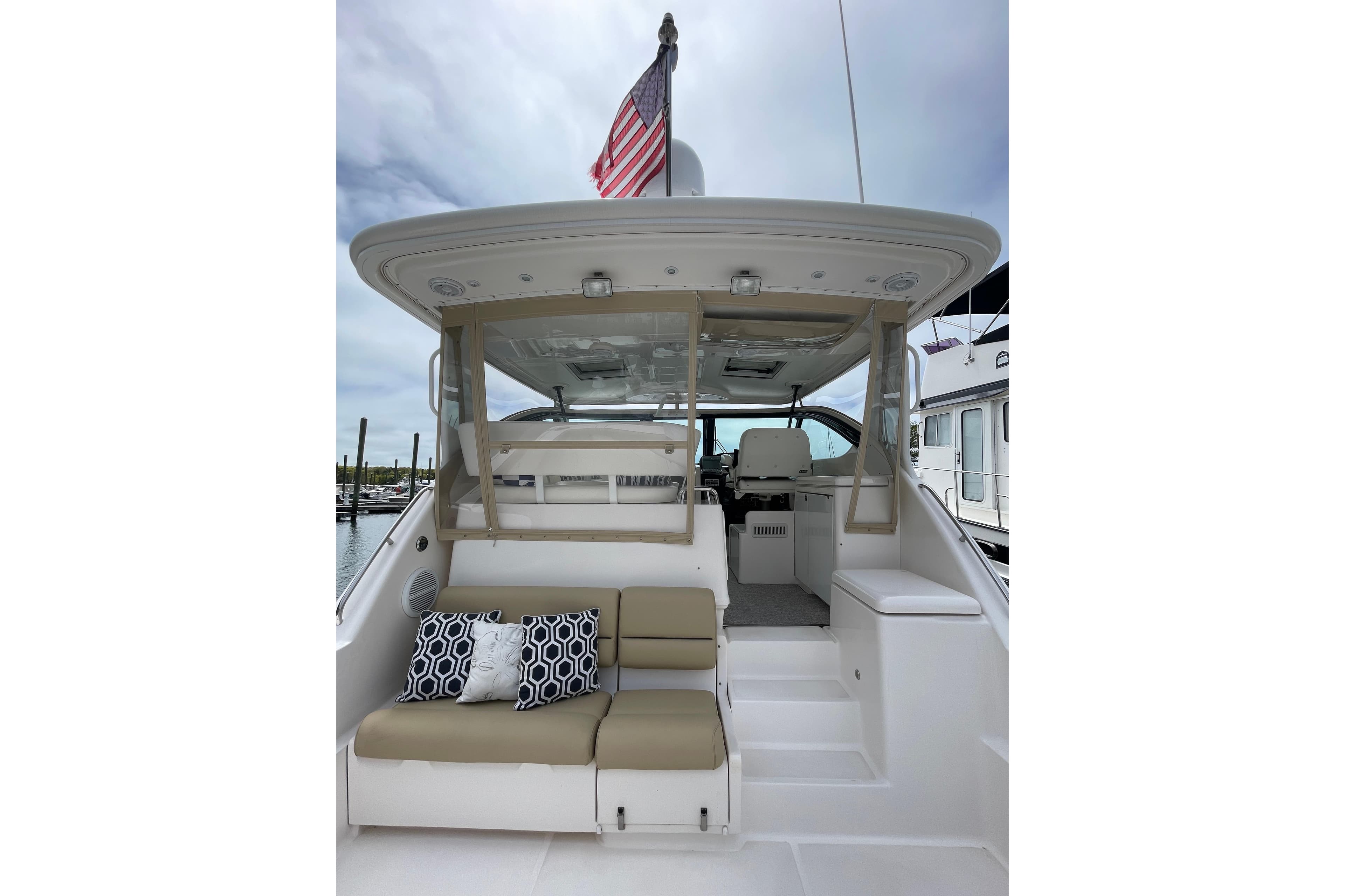 2009 Tiara Yachts 4200 Open with seating area and American flag.