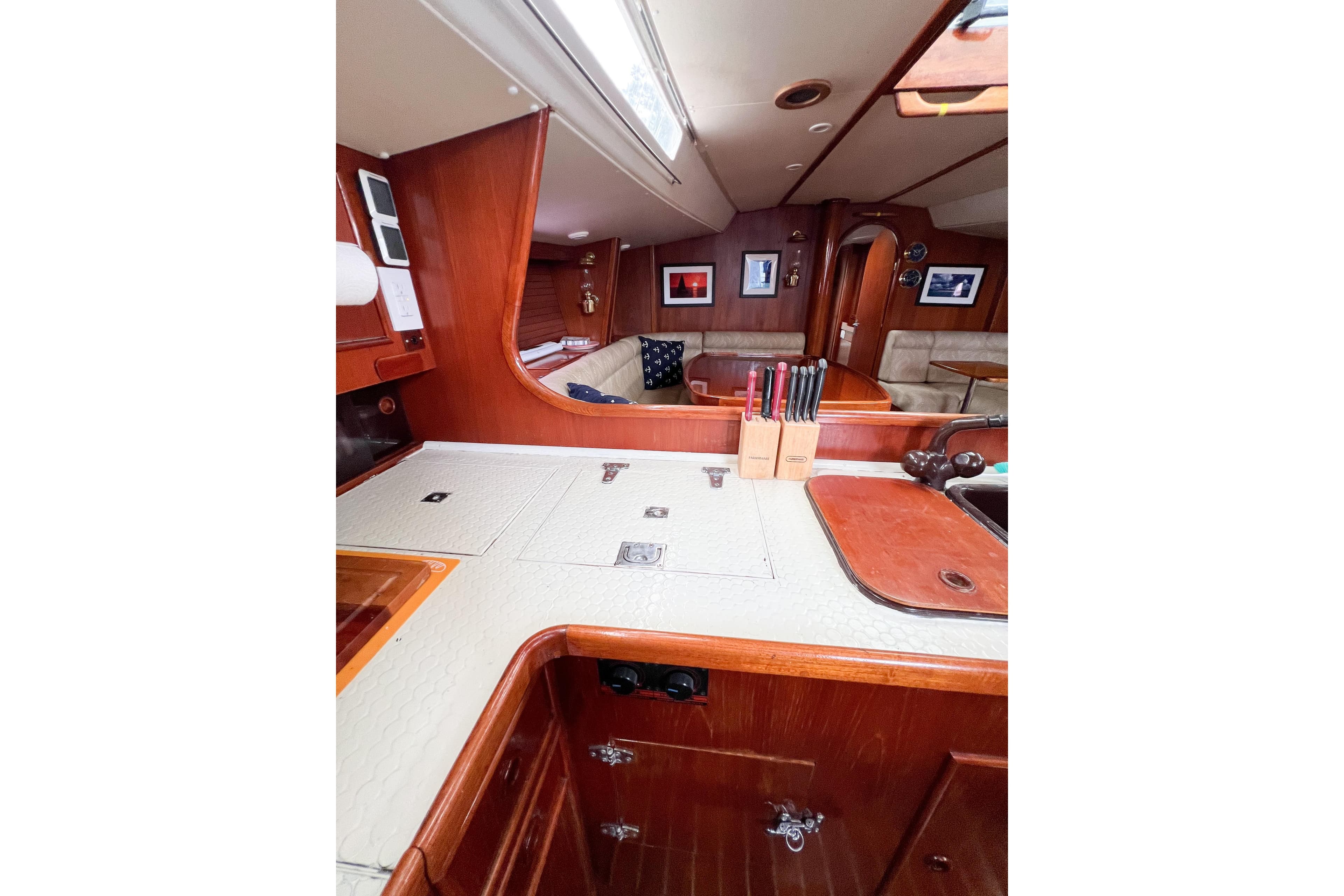 Interior of 1984 Trintella 42 yacht with wooden cabinetry and modern amenities.