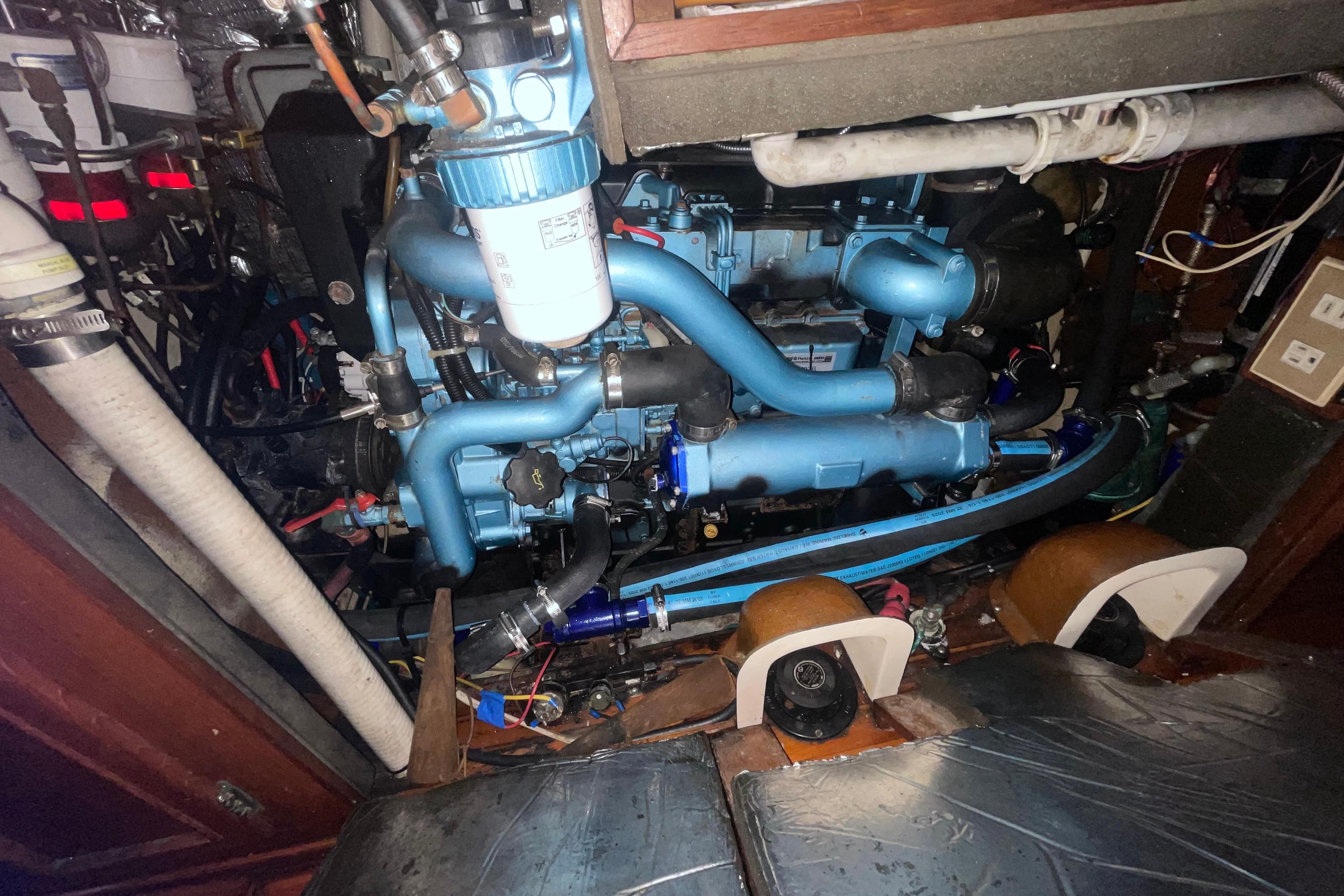 Engine compartment of a 1982 Stevens cutter sailboat, showcasing intricate mechanical components.