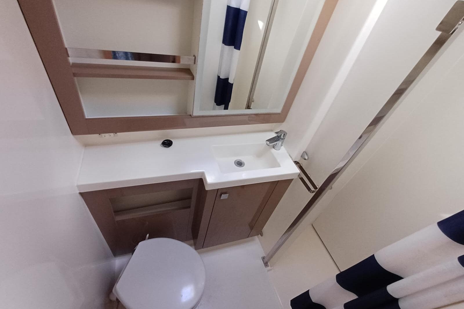 2018 Fountaine Pajot Saona 47 bathroom with modern sink, mirror, and shower curtain.