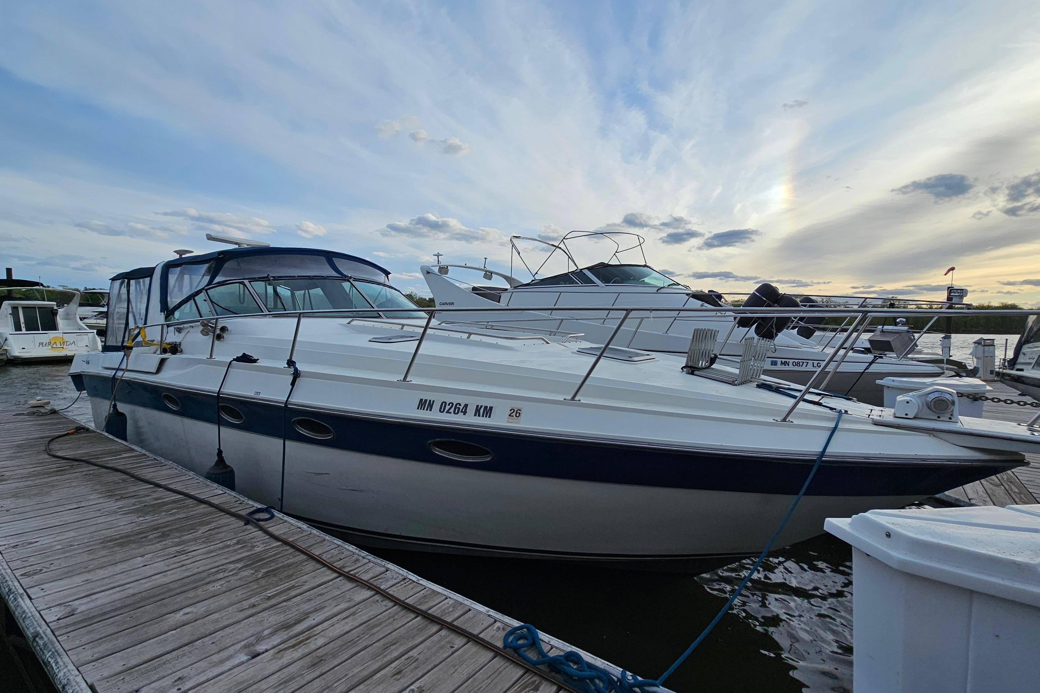 1988 Regal Commodore 360 yacht docked at marina under a cloudy sky.
