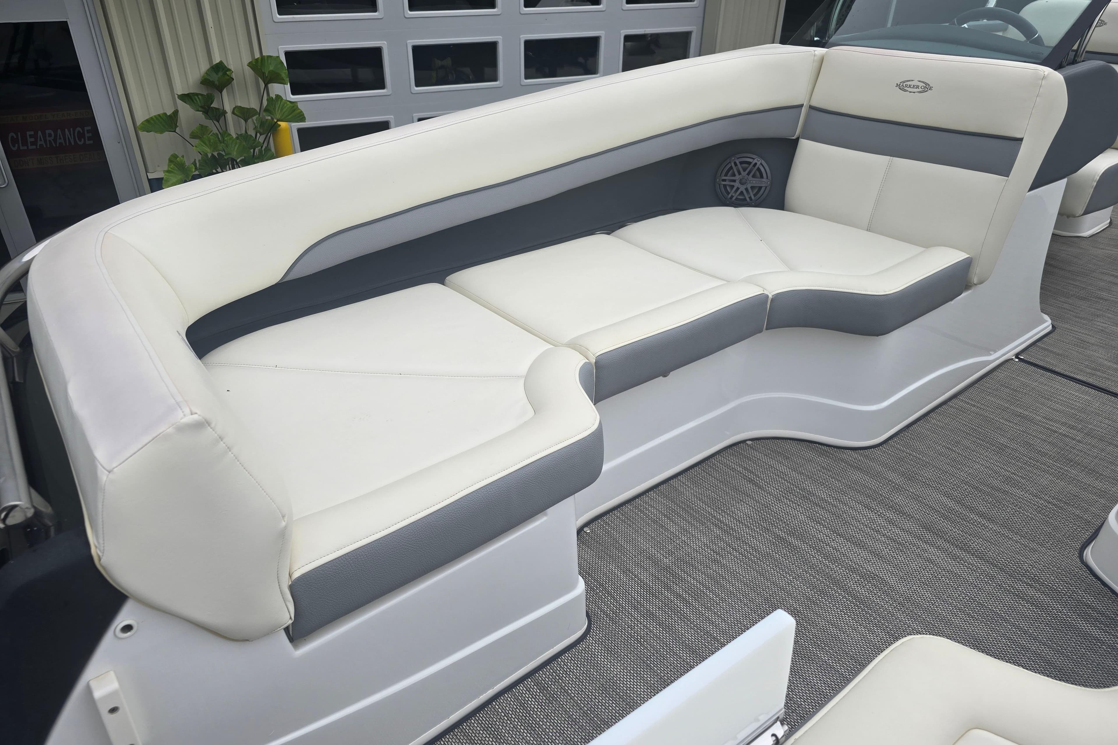 Luxurious seating on a 2016 Marker One ML4 boat, featuring white and gray upholstery.