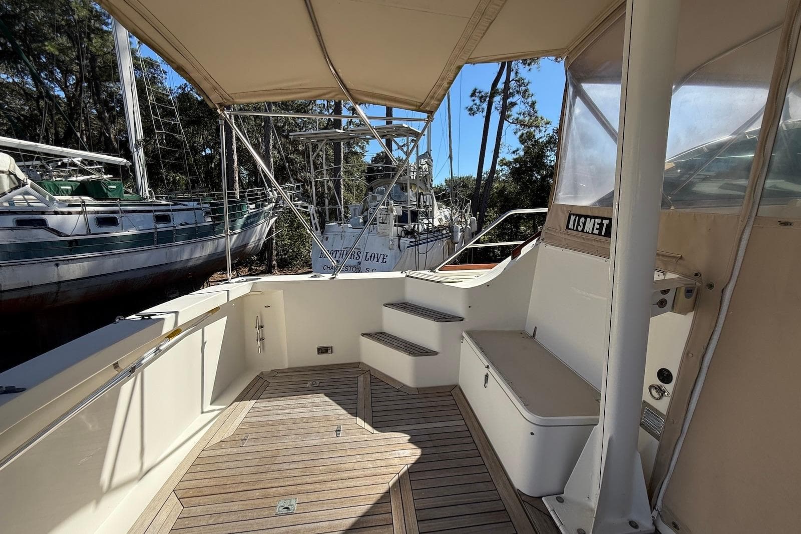 1999 Sabre 36 Express boat deck with wooden flooring and canopy.