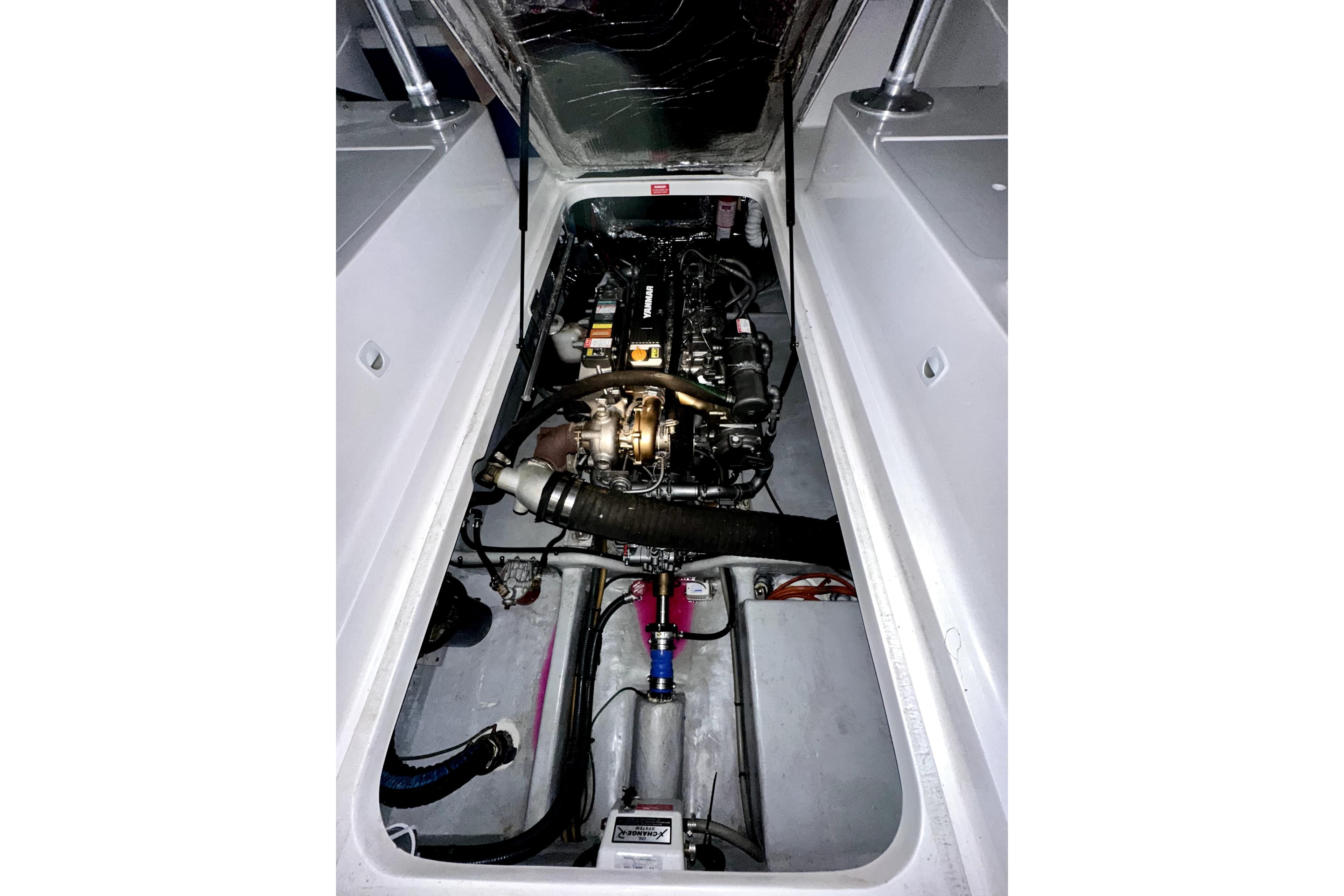 Engine compartment of a 2003 Mainship Pilot 30-II boat, showcasing mechanical components.