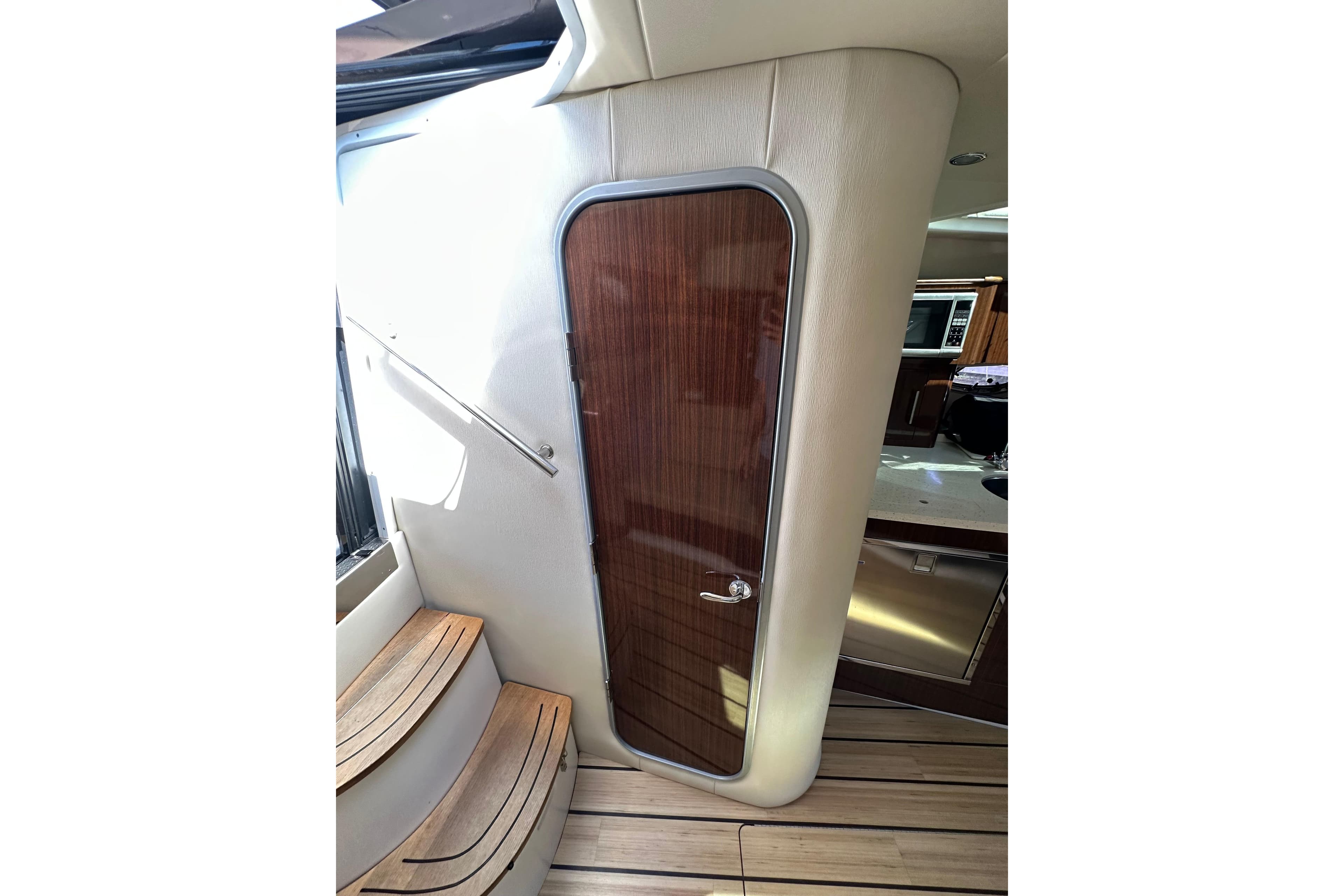 Interior of 2014 Regal 35 Sport Coupe with wooden door and steps.