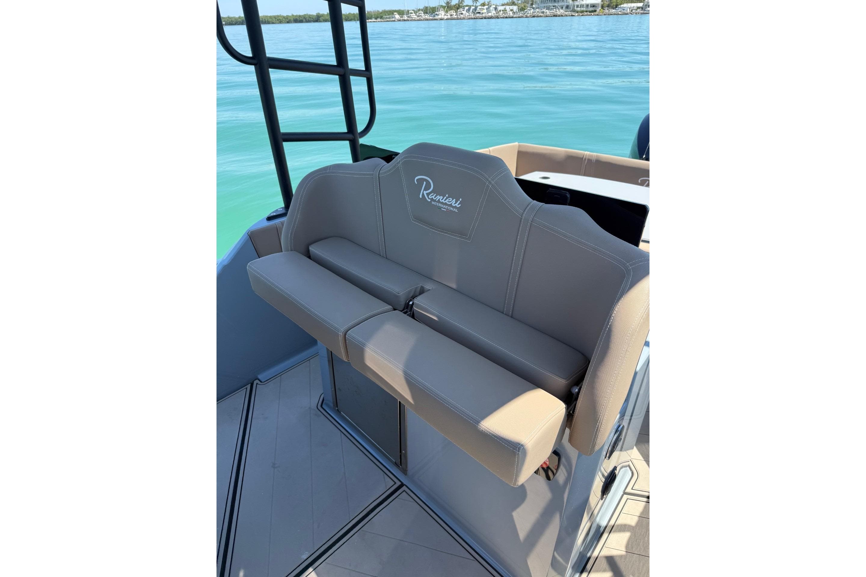 2026 Ranieri Cayman Executive boat seat with elegant design on calm blue water.