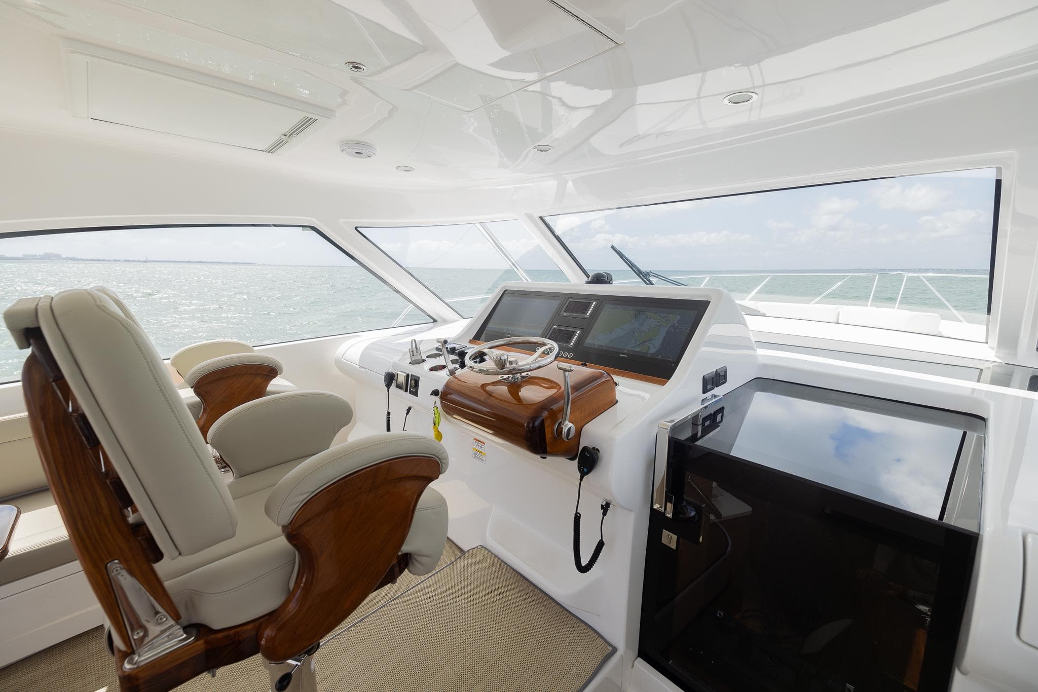 Luxurious 2022 Bertram 50 yacht helm with modern controls and plush seating.
