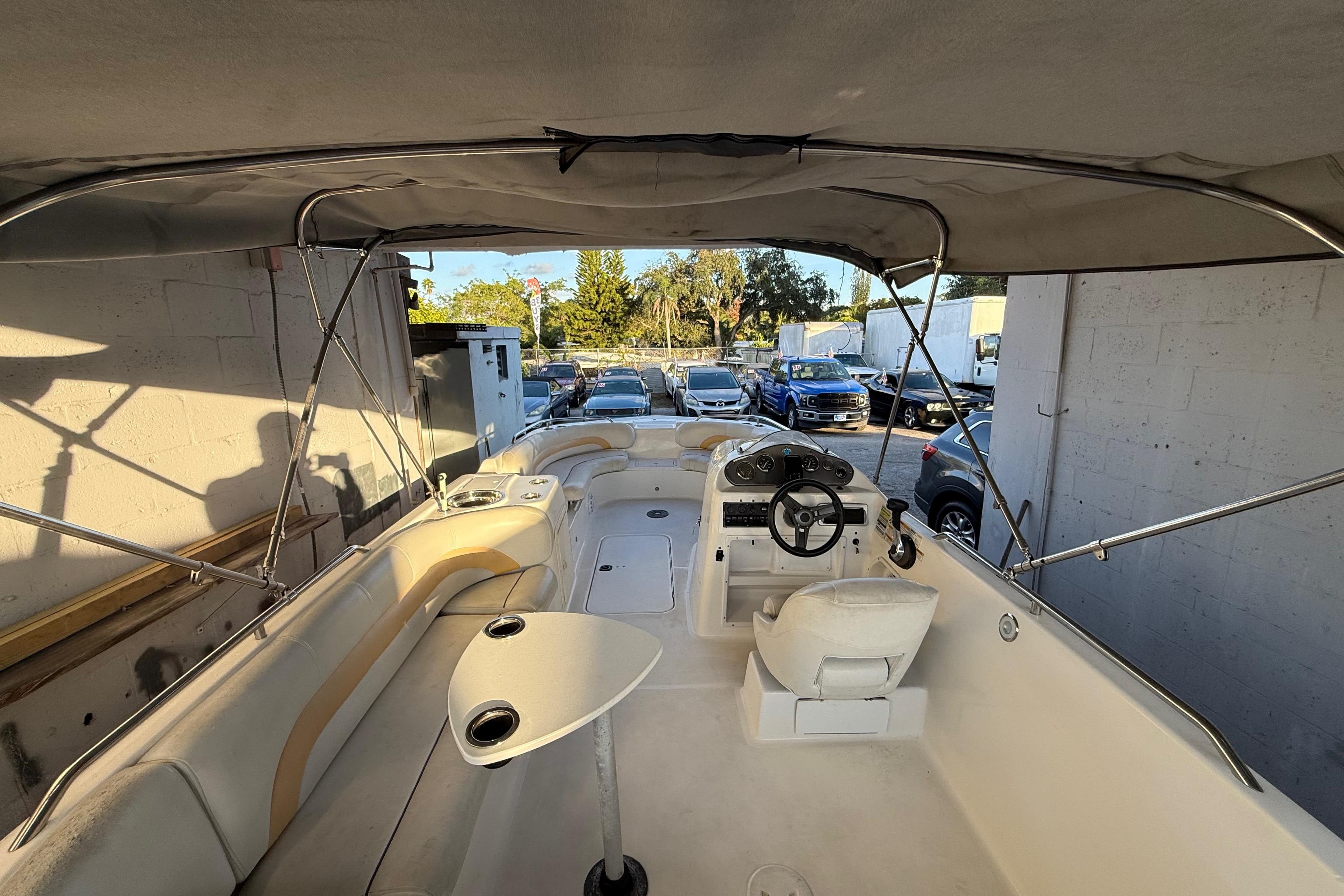2016 Hurricane SunDeck Sport 232 OB boat interior with canopy and seating.