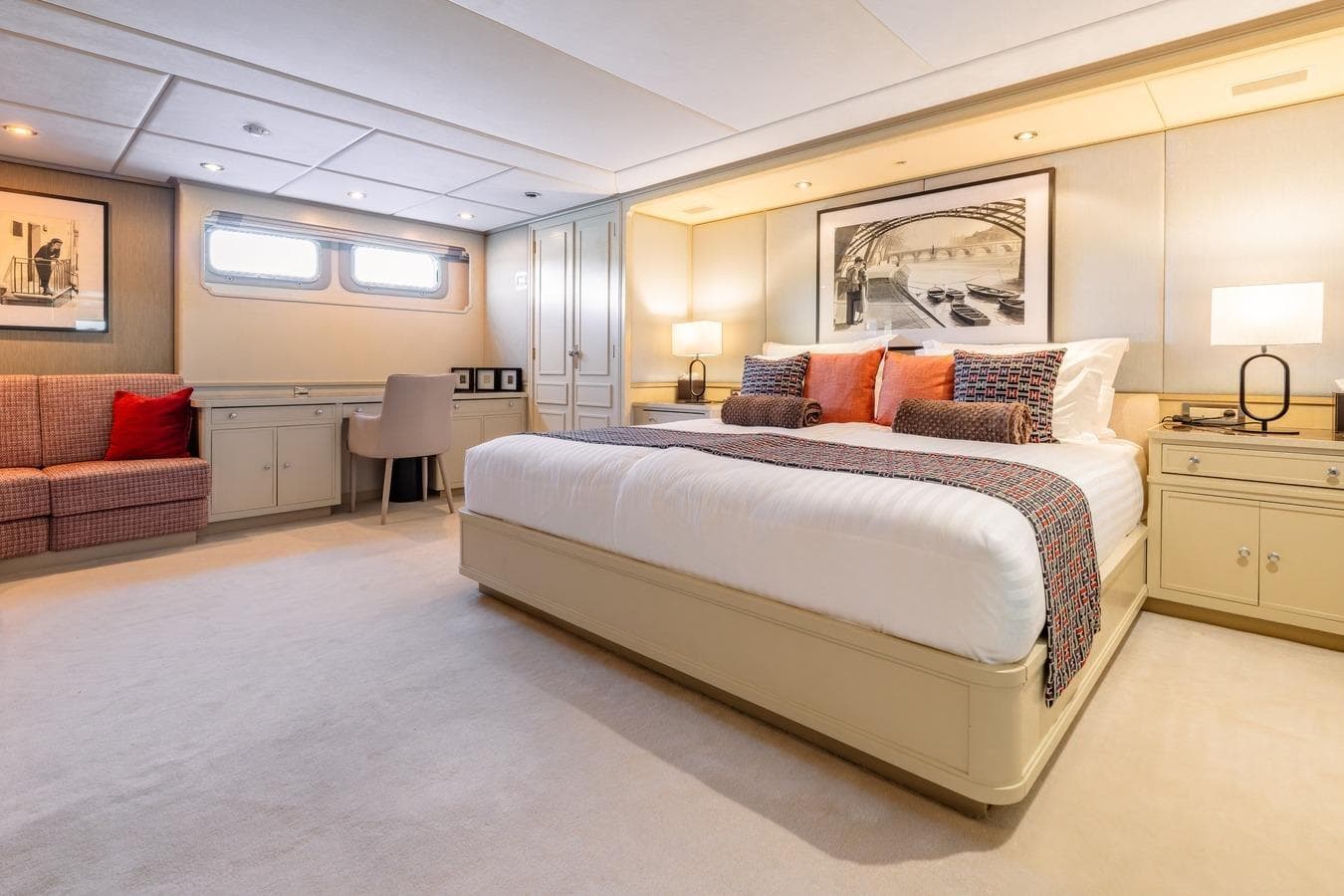 Luxurious 1983 Feadship 55 yacht bedroom with elegant decor and comfortable furnishings.