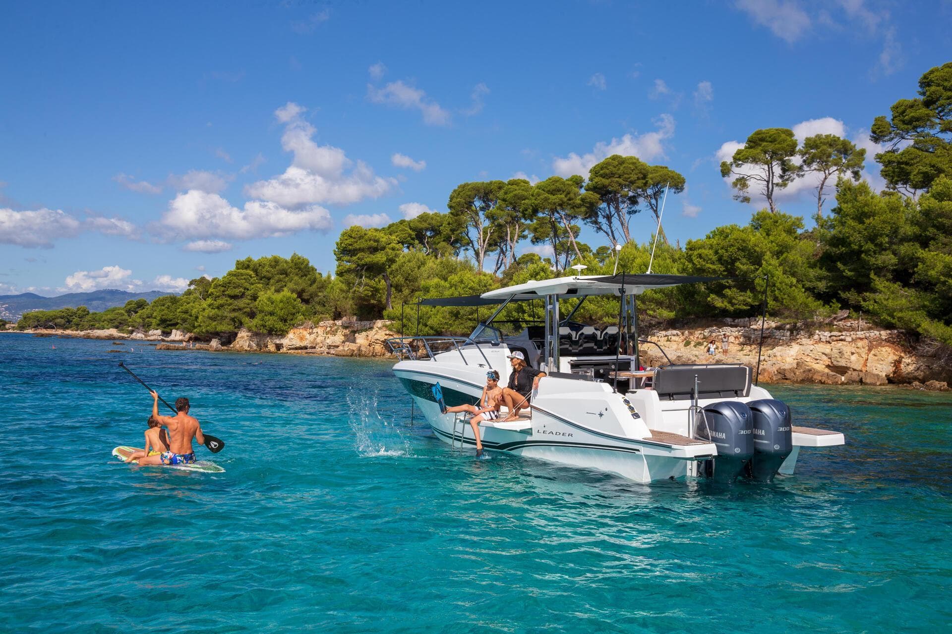 2025 Jeanneau Leader 10.5 WA Series 2 in turquoise waters, people enjoying water activities.